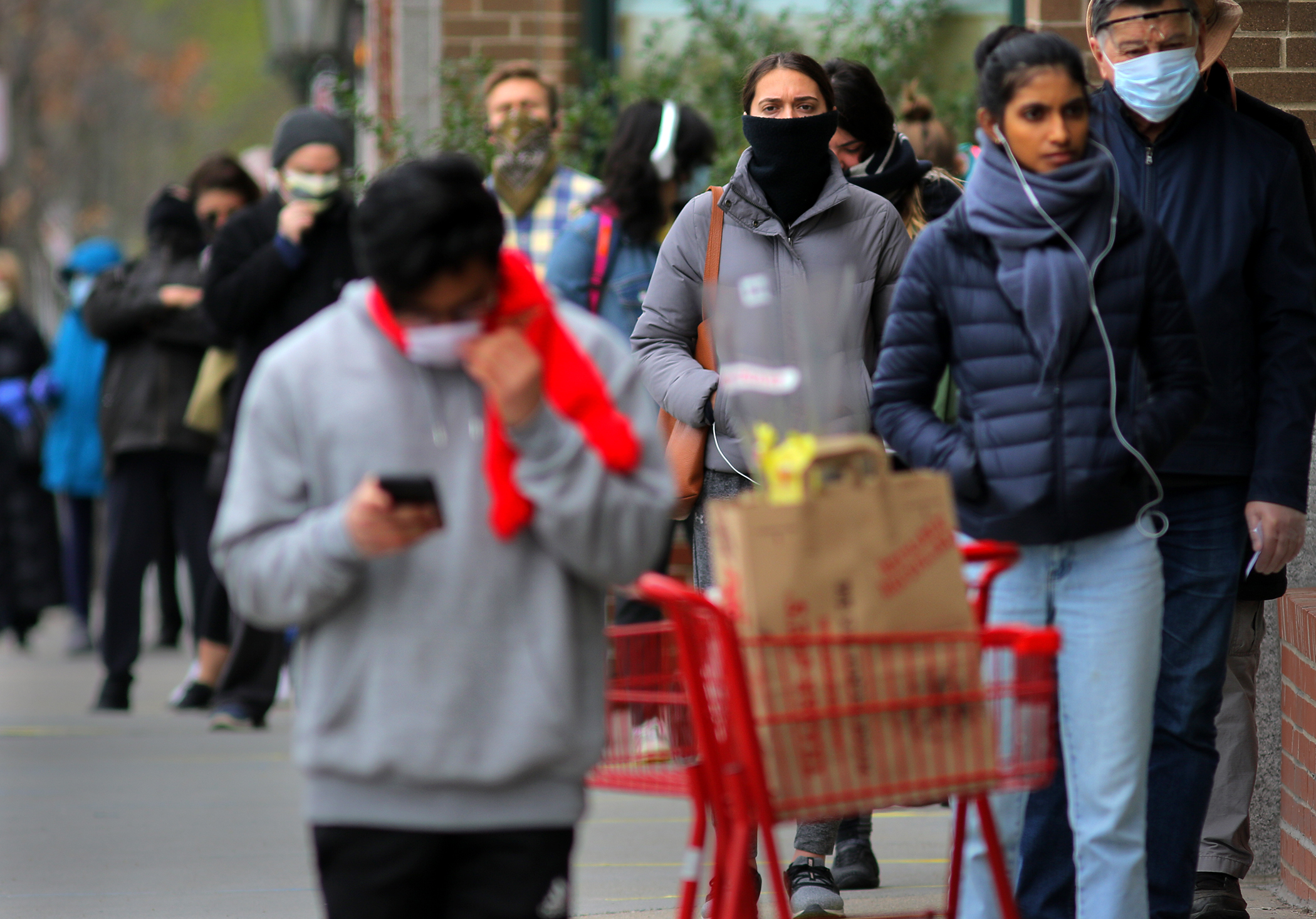 Customers lined up outside the Trader Joe's grocery store in Coolidge Corner, which limits the number of people inside.