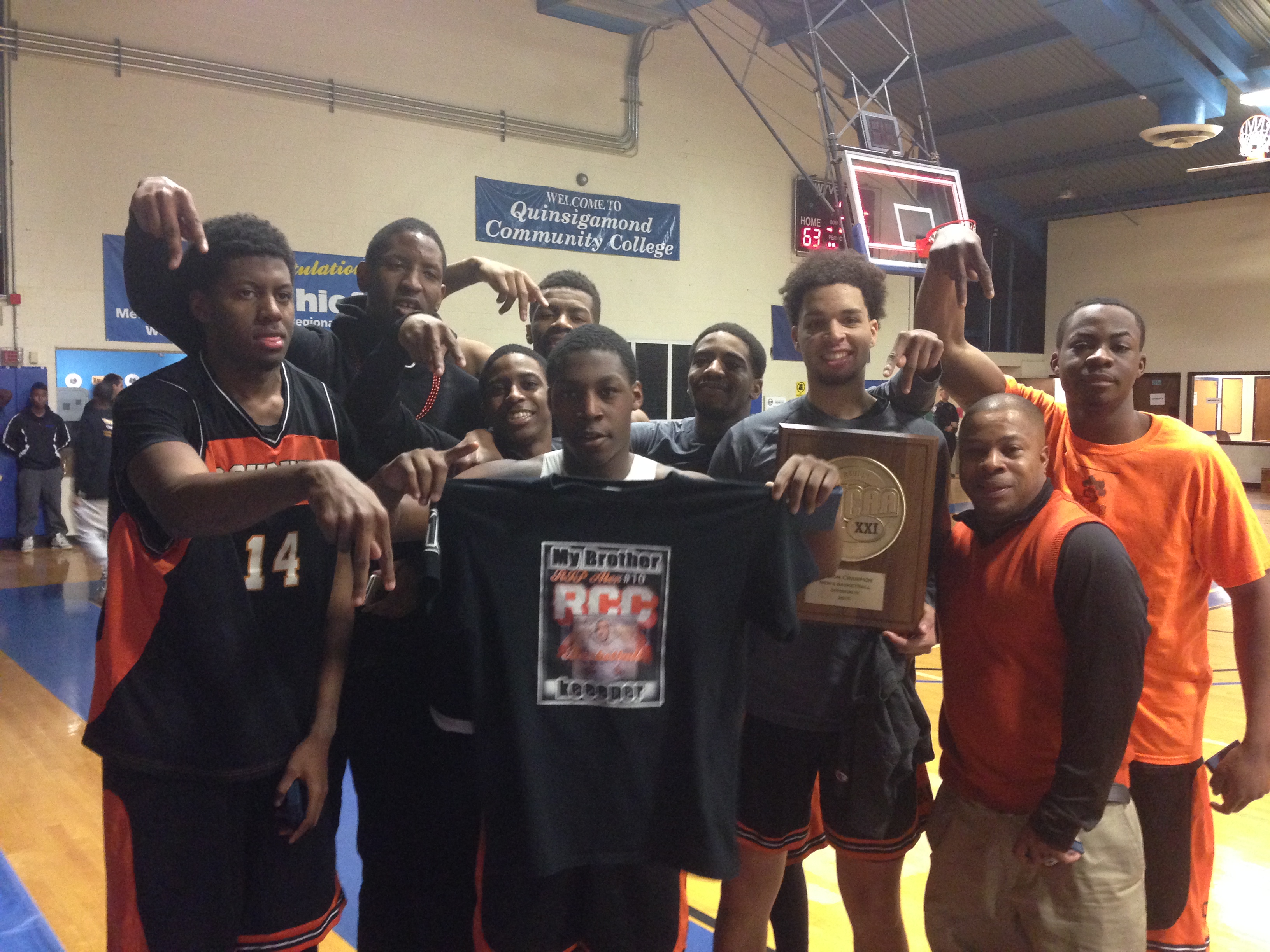 The Roxbury men’s basketball team showed off its t-shirts in memory of teammate Alex DoSouto after Roxbury won a regional tournament.