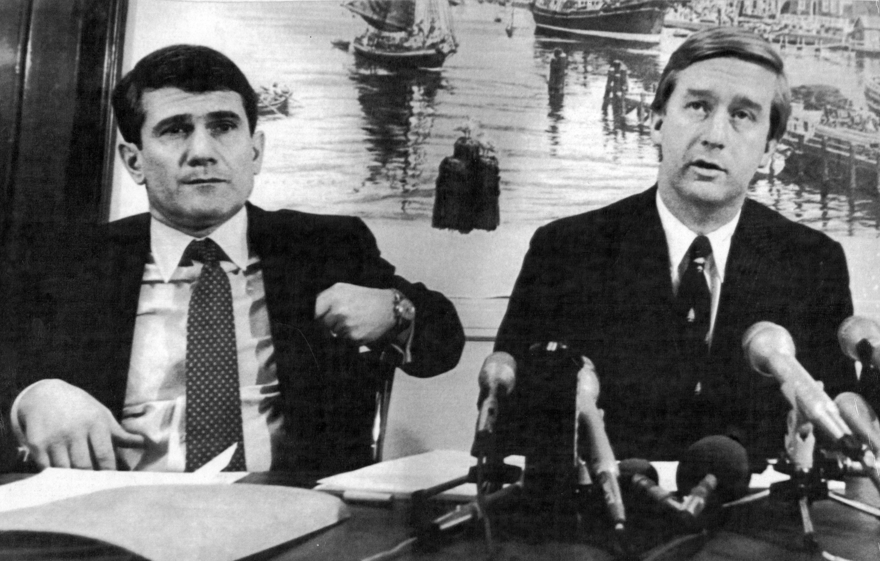 Deland looked on at the left as U.S. Attorney William Weld (right) announced a federal lawsuit aimed at spurring the $2 billion cleanup of the pollution in the Boston Harbor during a press conference.