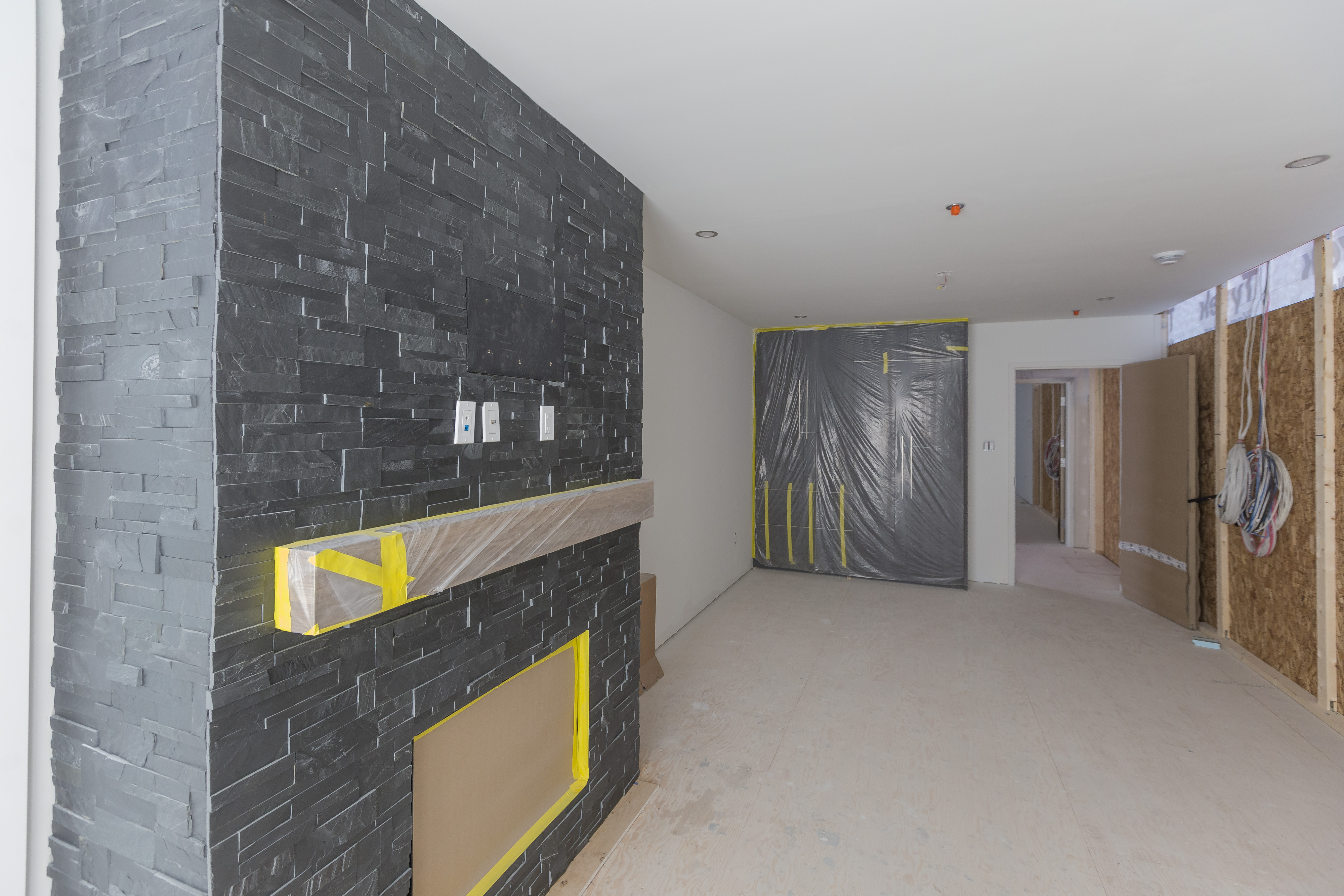 A living room with a fireplace inside a modular home, used in some cases for apartments, is prepared for shipping.