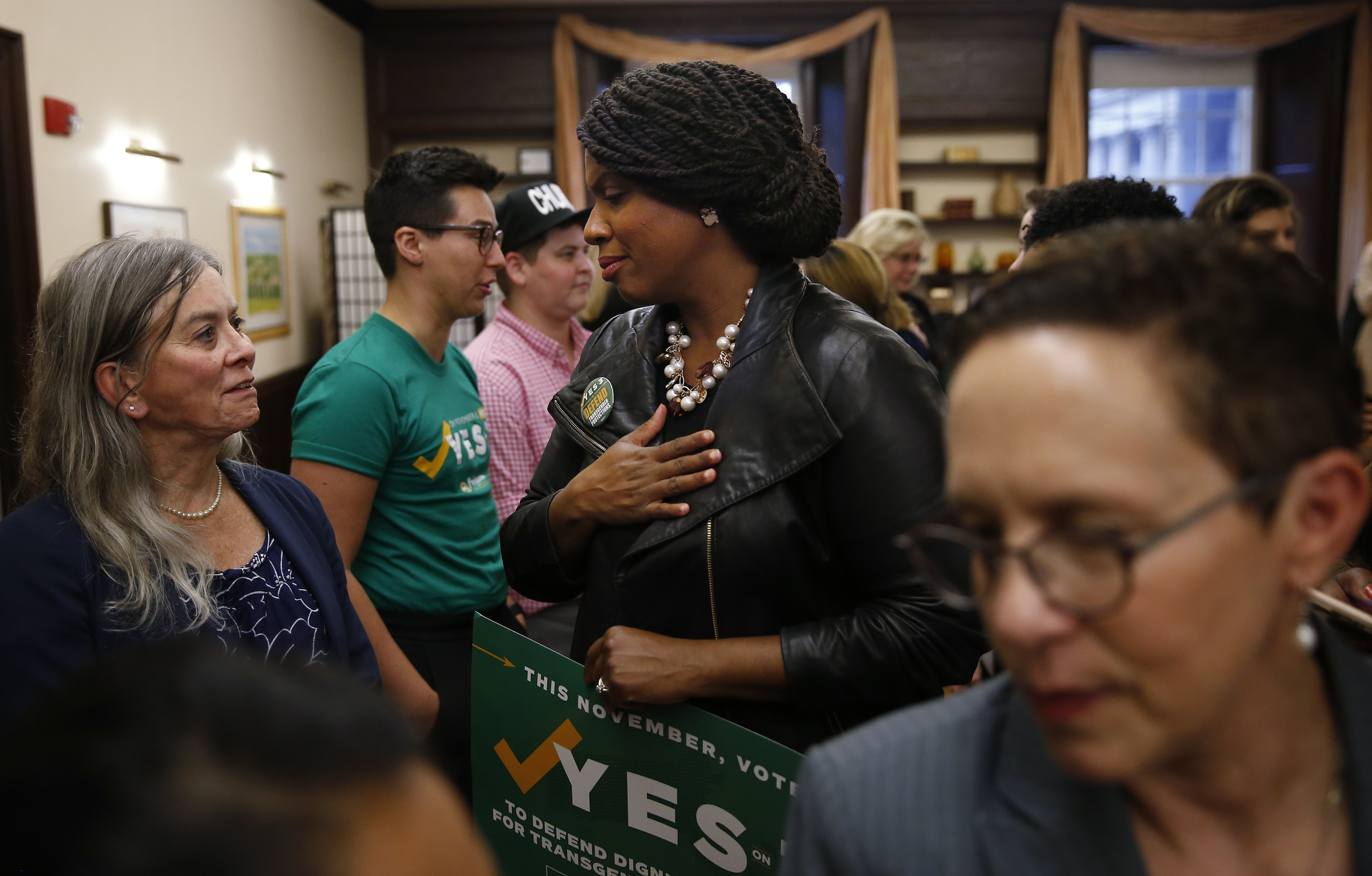 Democratic congressional nominee Ayanna Pressley (center)spoke with Sara Schnorr, (left) a transgender attorney.