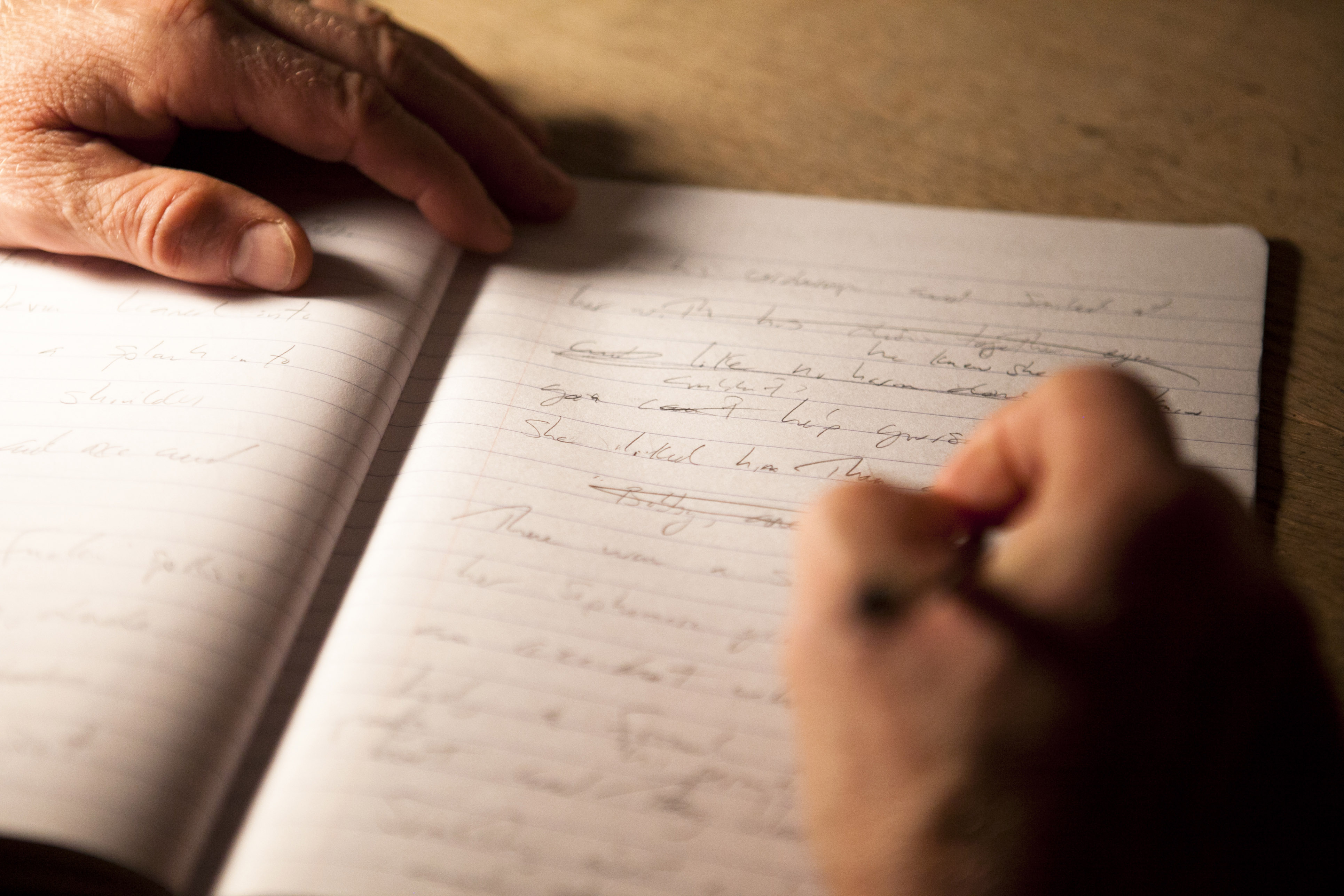 Dubre looked through a composition notebook containing his writing from his latest book.