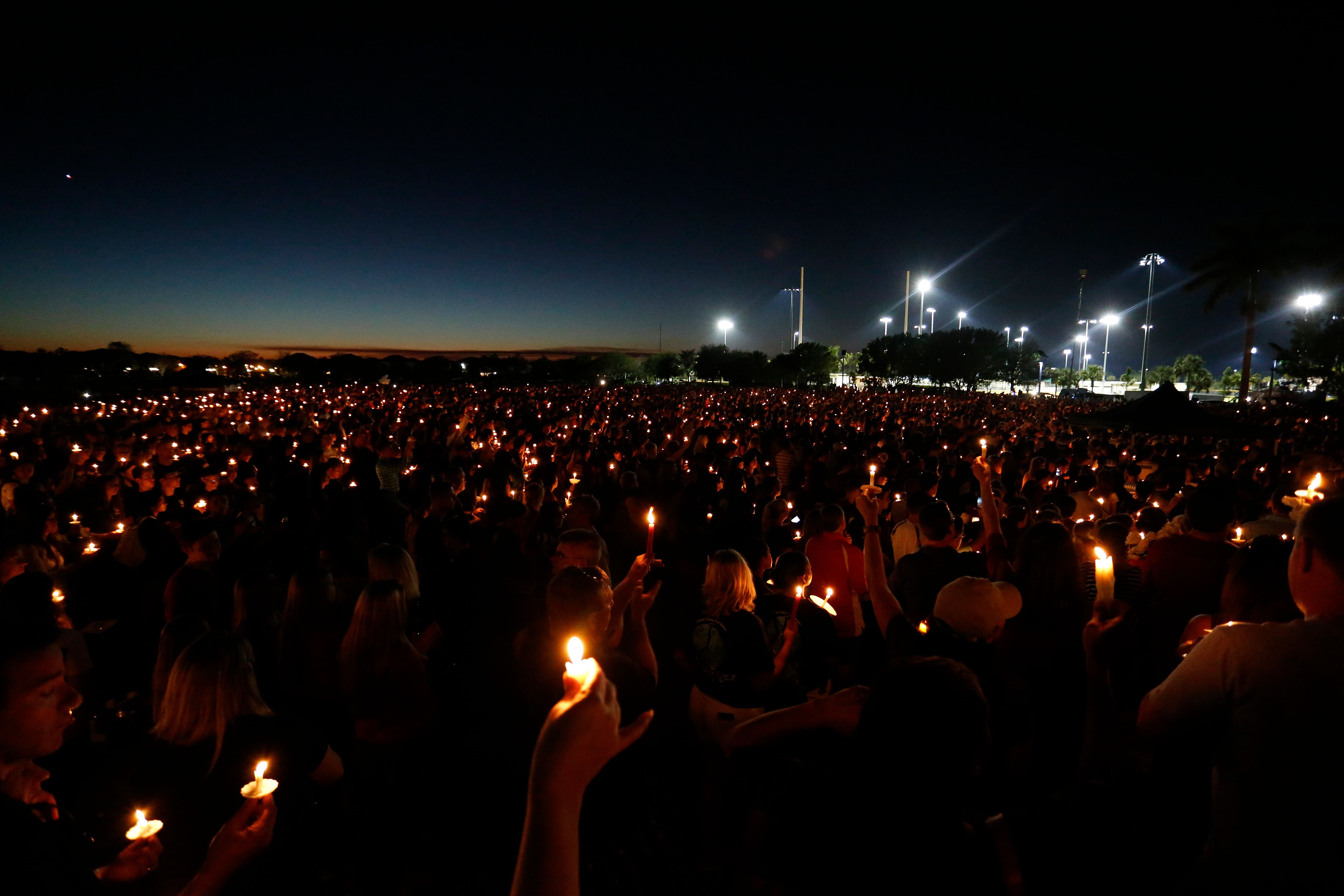 Mourners attended a candlelight vigil for victims of Marjory Stoneman Douglas High School shooting in Parkland, Florida on Thursday.