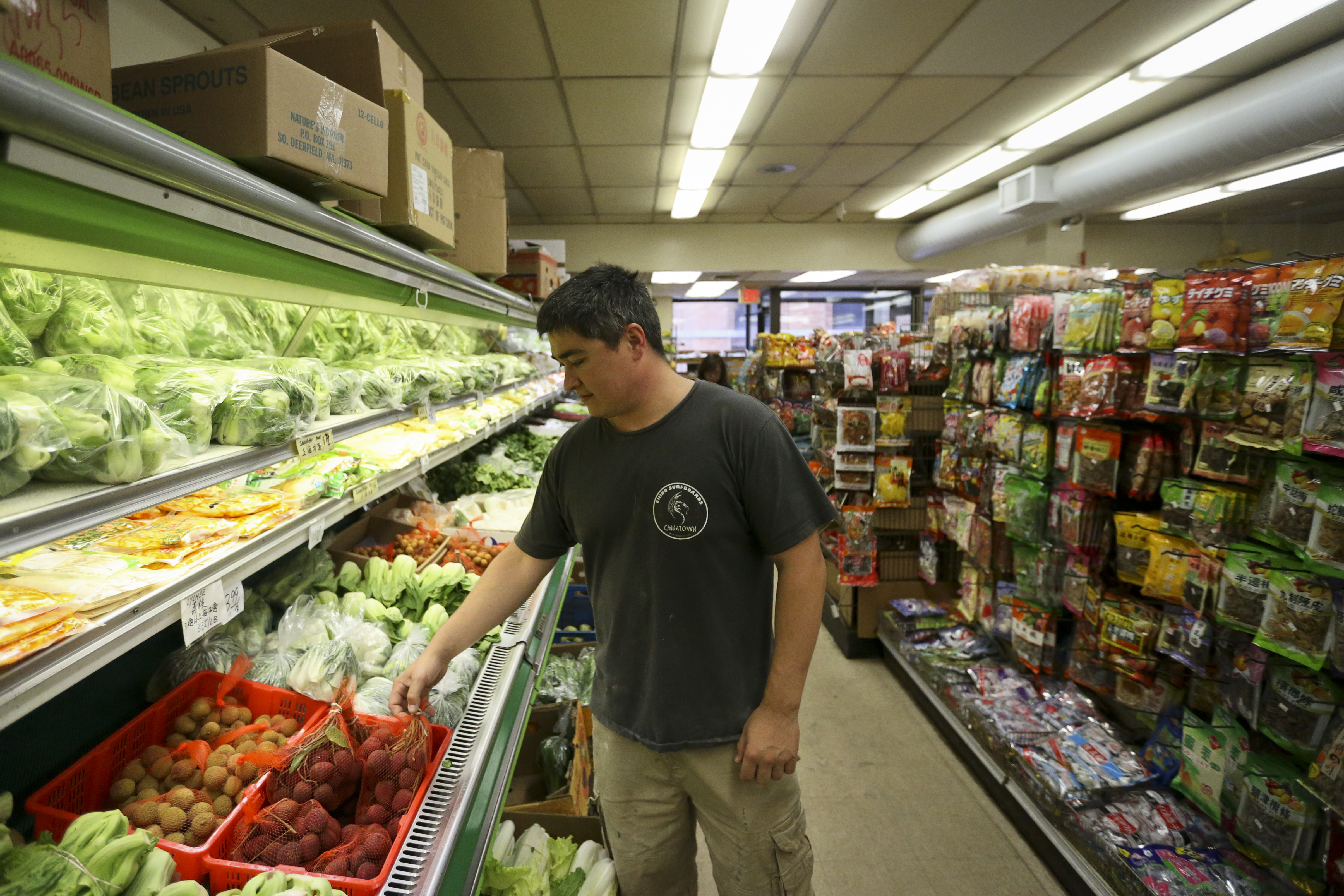 Jonathan Wong looked over items in his family’s shop, Sun Sun, in Chinatown.