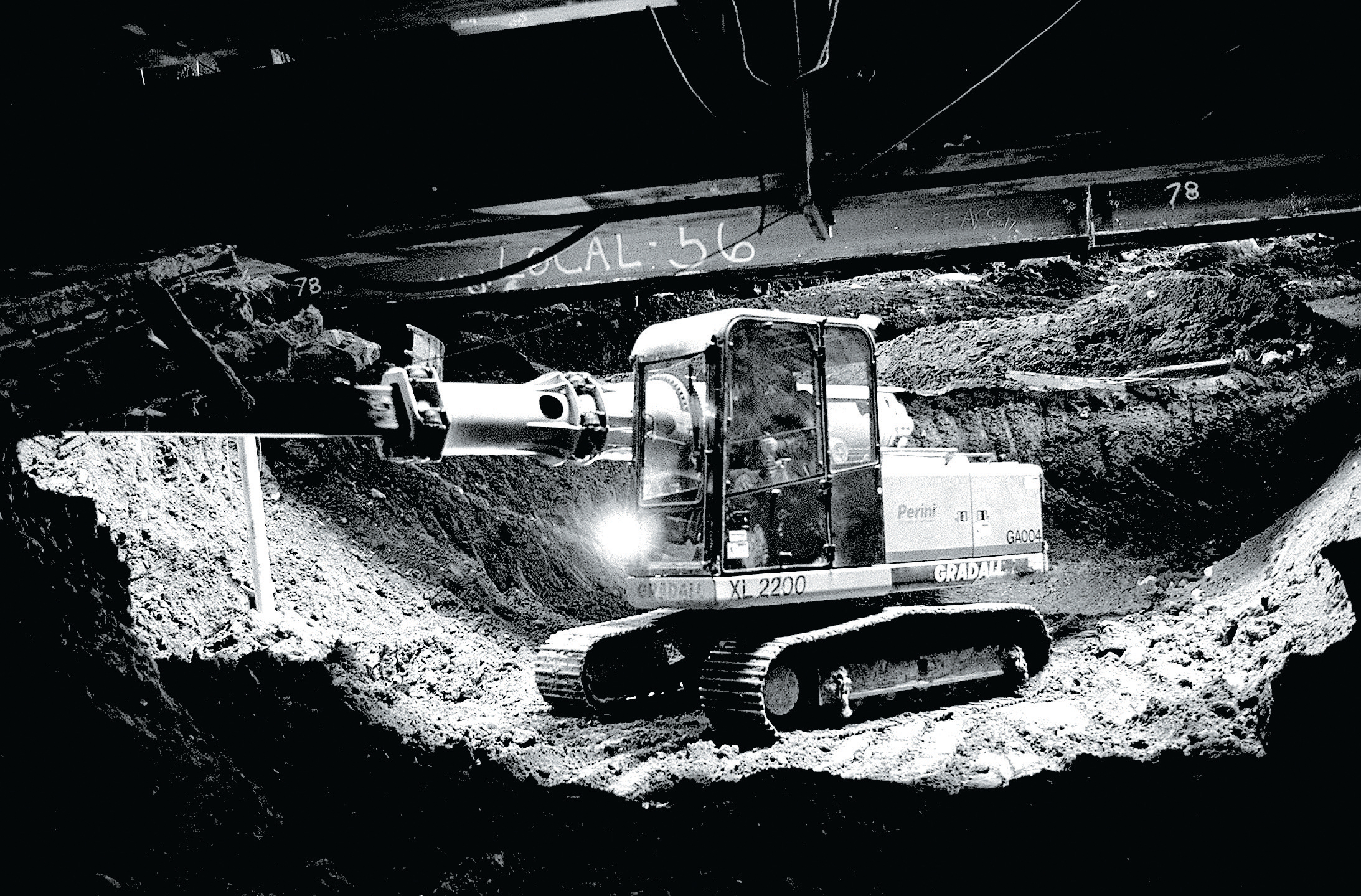 A worker moves earth near the Red Line.