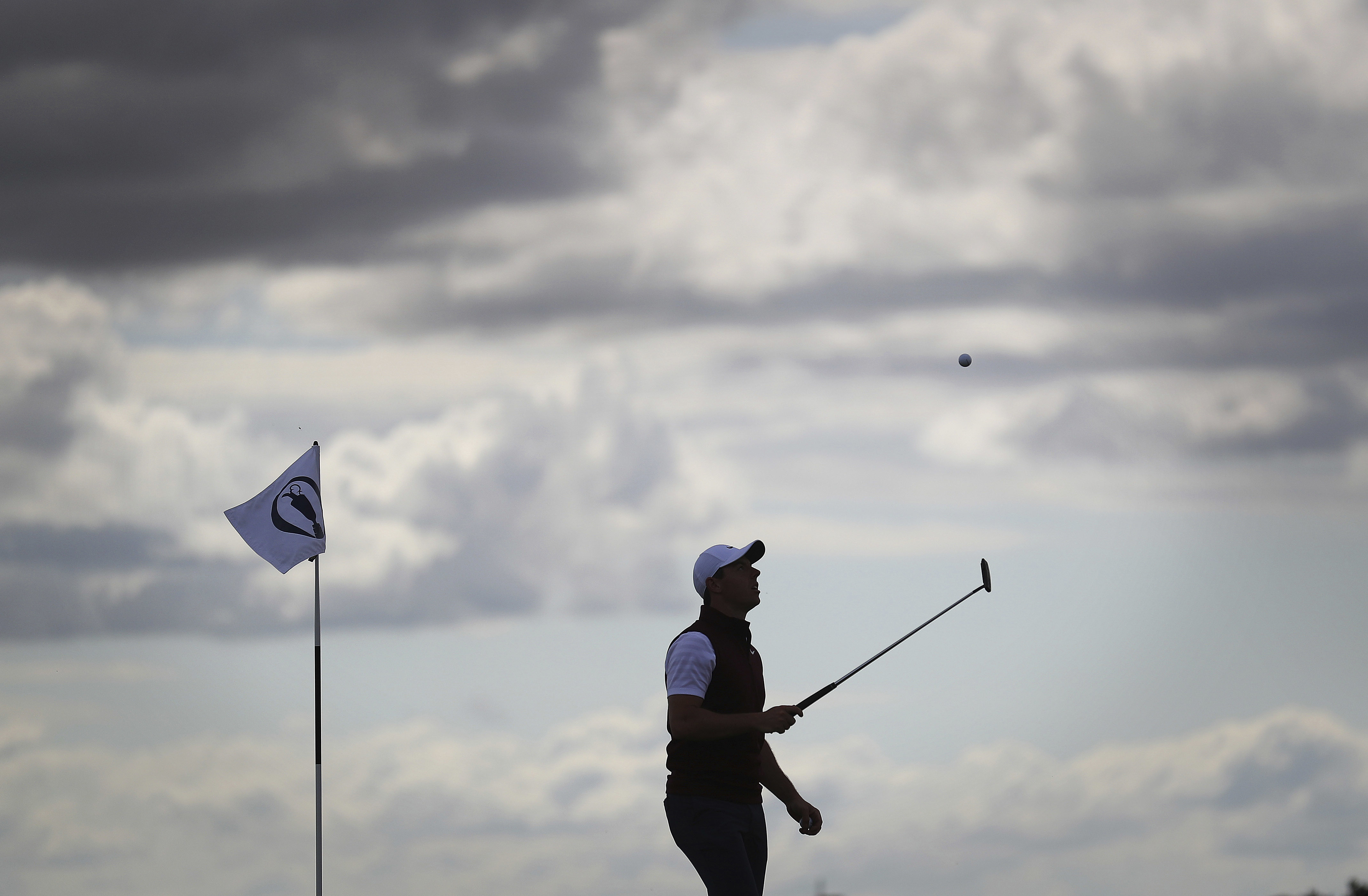 Rory McIlroy is silhouetted on the 16th green during a practice round for the British Open.