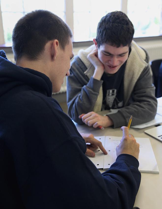 Seniors Davis Rochester (left) and Lucas Cassels worked on a problem during an advanced calculus class that integrates computer coding at Beaver Country Day School in Brookline.