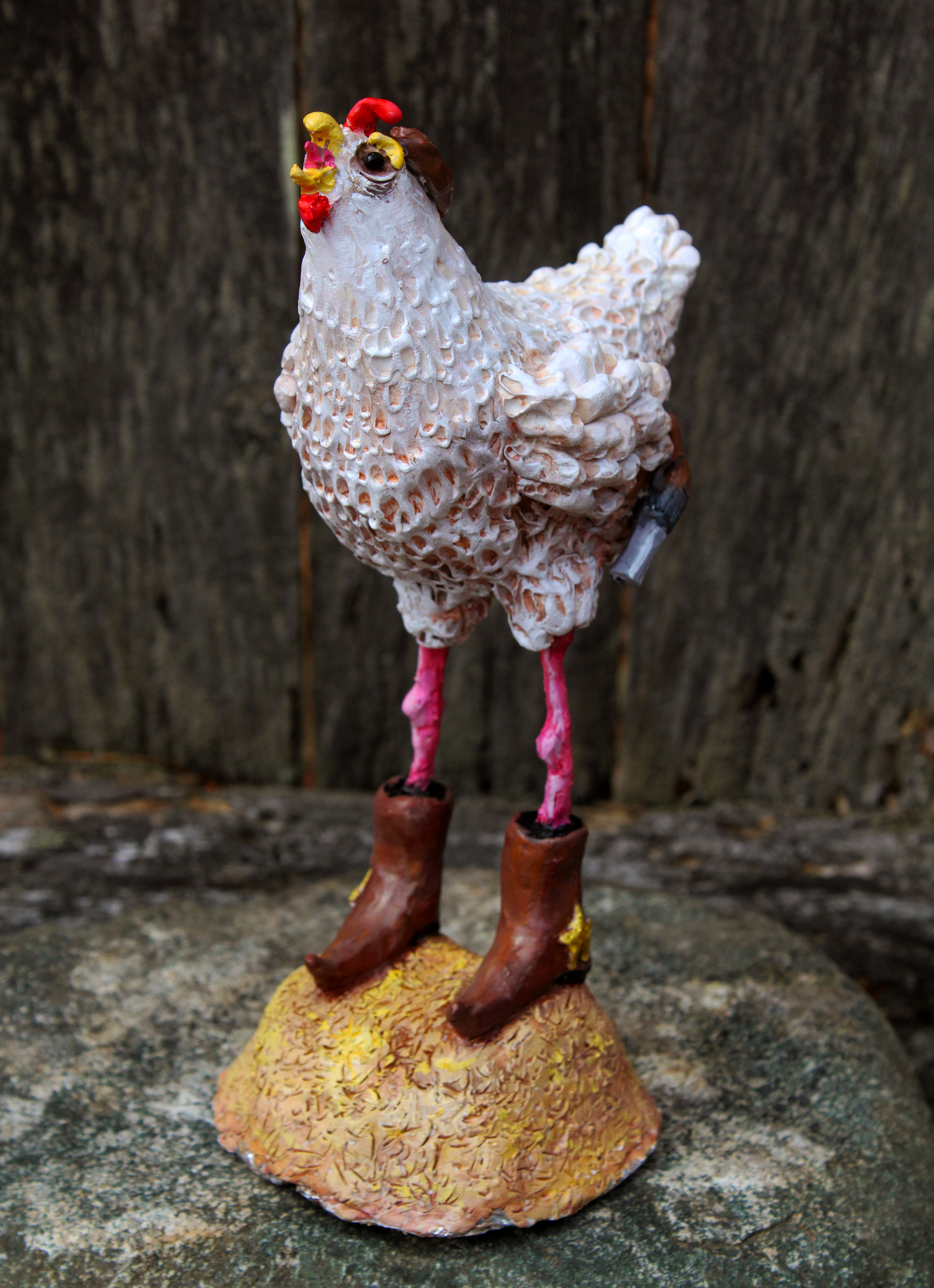 Sara Micciche's "Cowboy Chicken" is made of clay and acrylic paint with an aluminum foil and wire base.