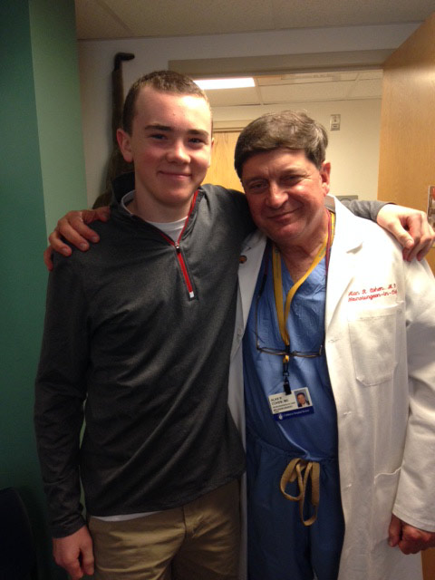 Patient Wyatt Schlaht, 14, with Dr. Al Cohen at a follow-up visit after surgery.