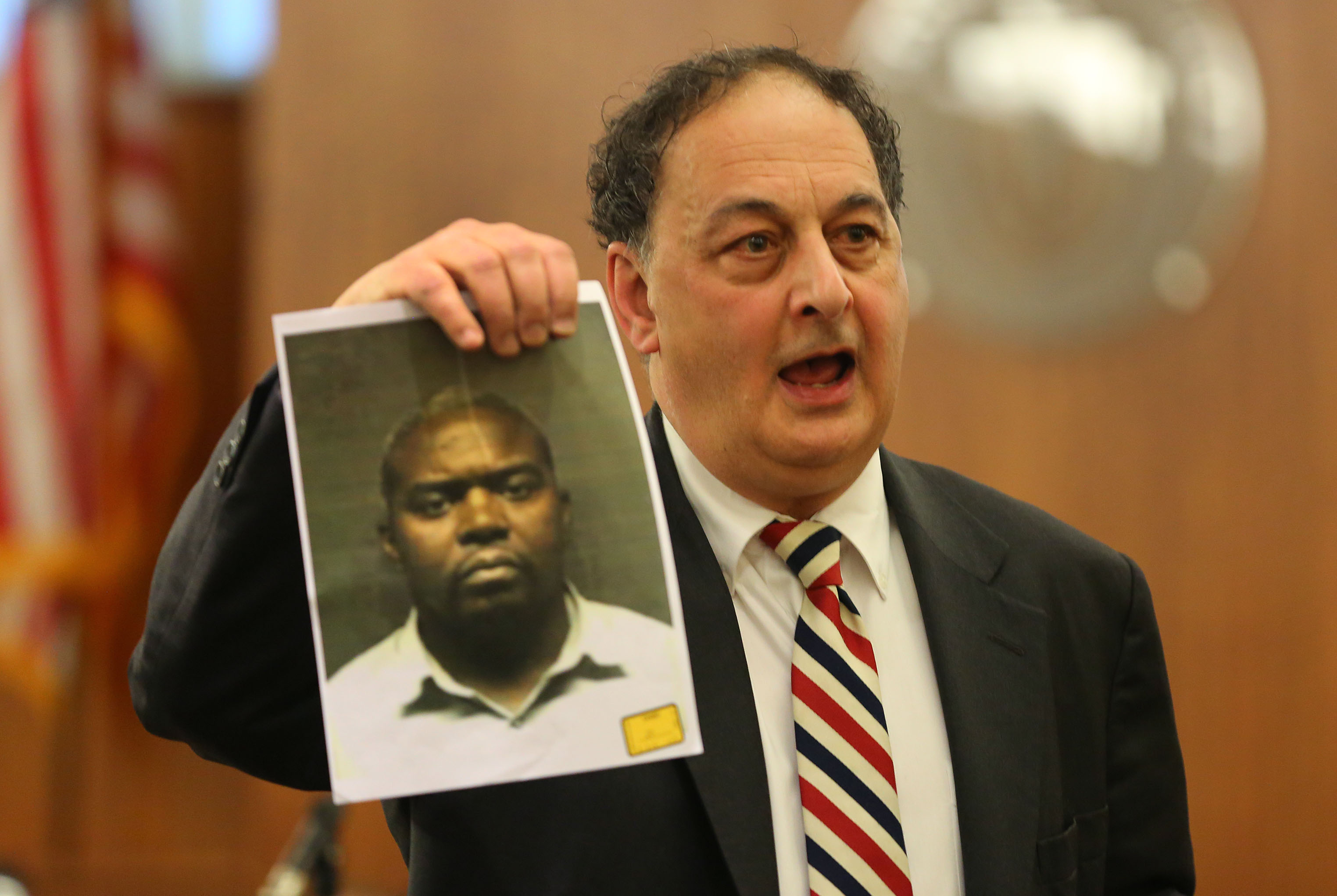 Defense attorney James Sultan held up a photo of Hernandez friend Ernest Wallace during closing arguments.
