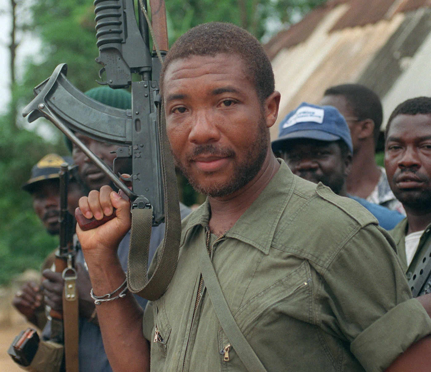 An assault rifle-toting Charles G. Taylor as a rebel leader in Liberia in 1990.
