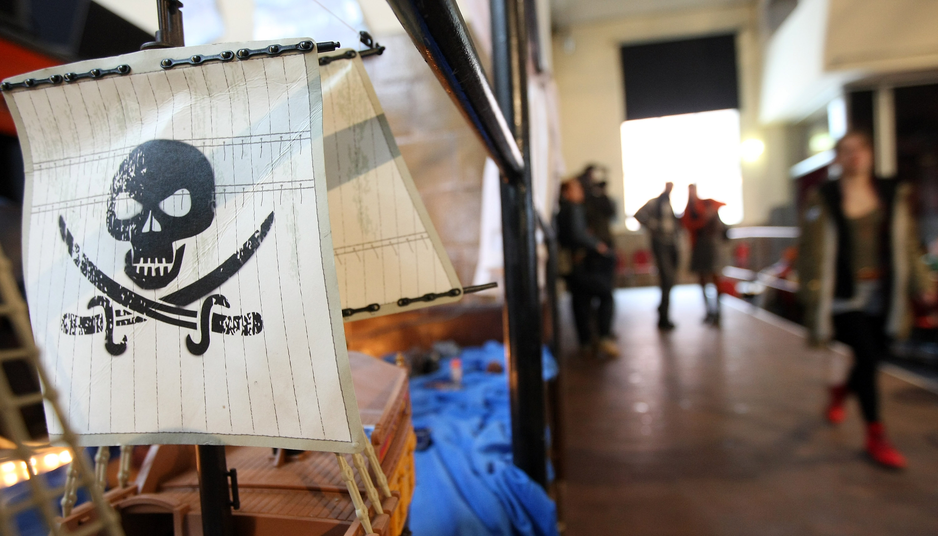 A Jolly Roger flag on a toy pirate ship at a meeting of the German Pirate Party.