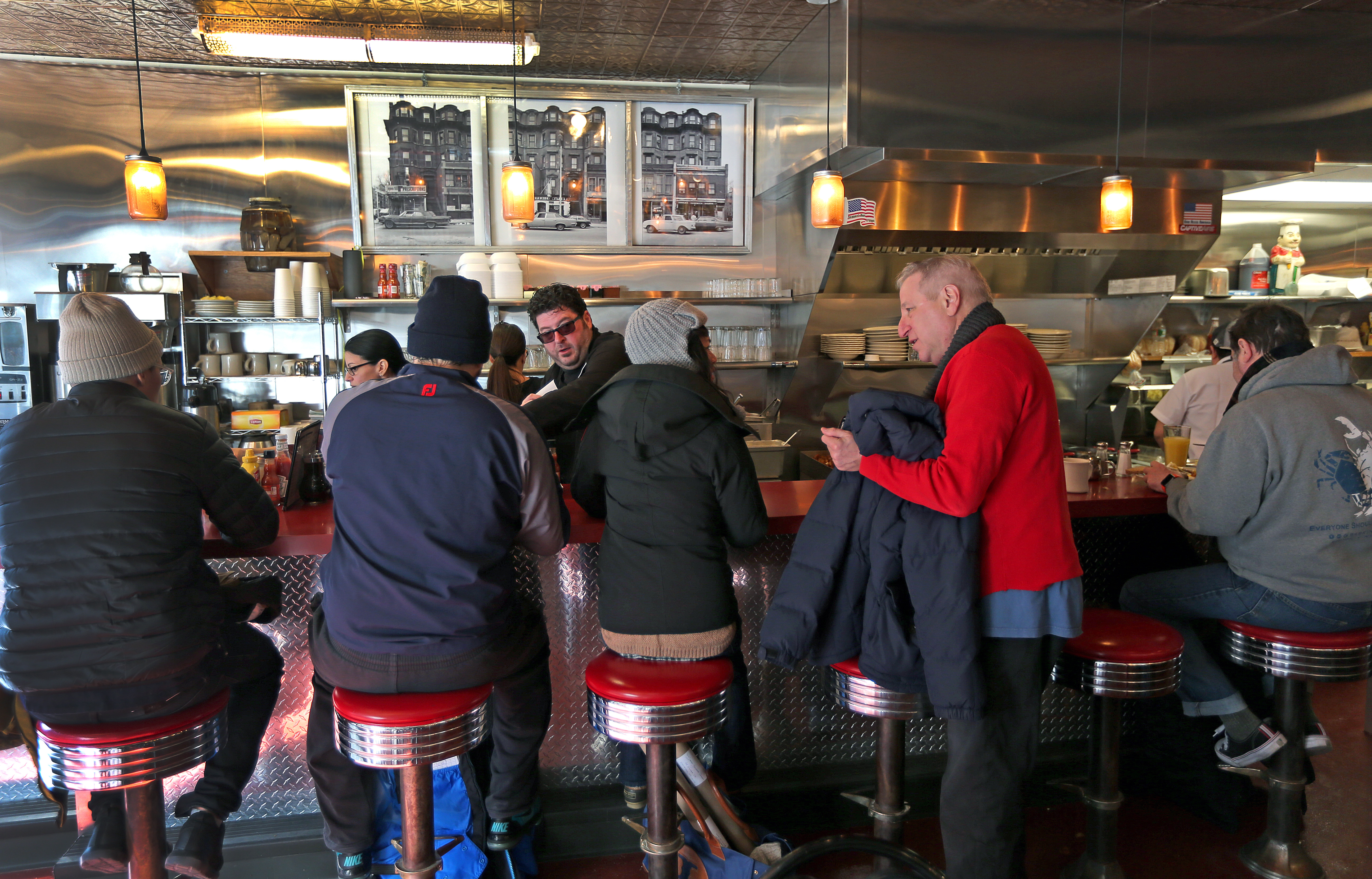 Restaurant owner Evan Deluty greeted customers behind the counter.