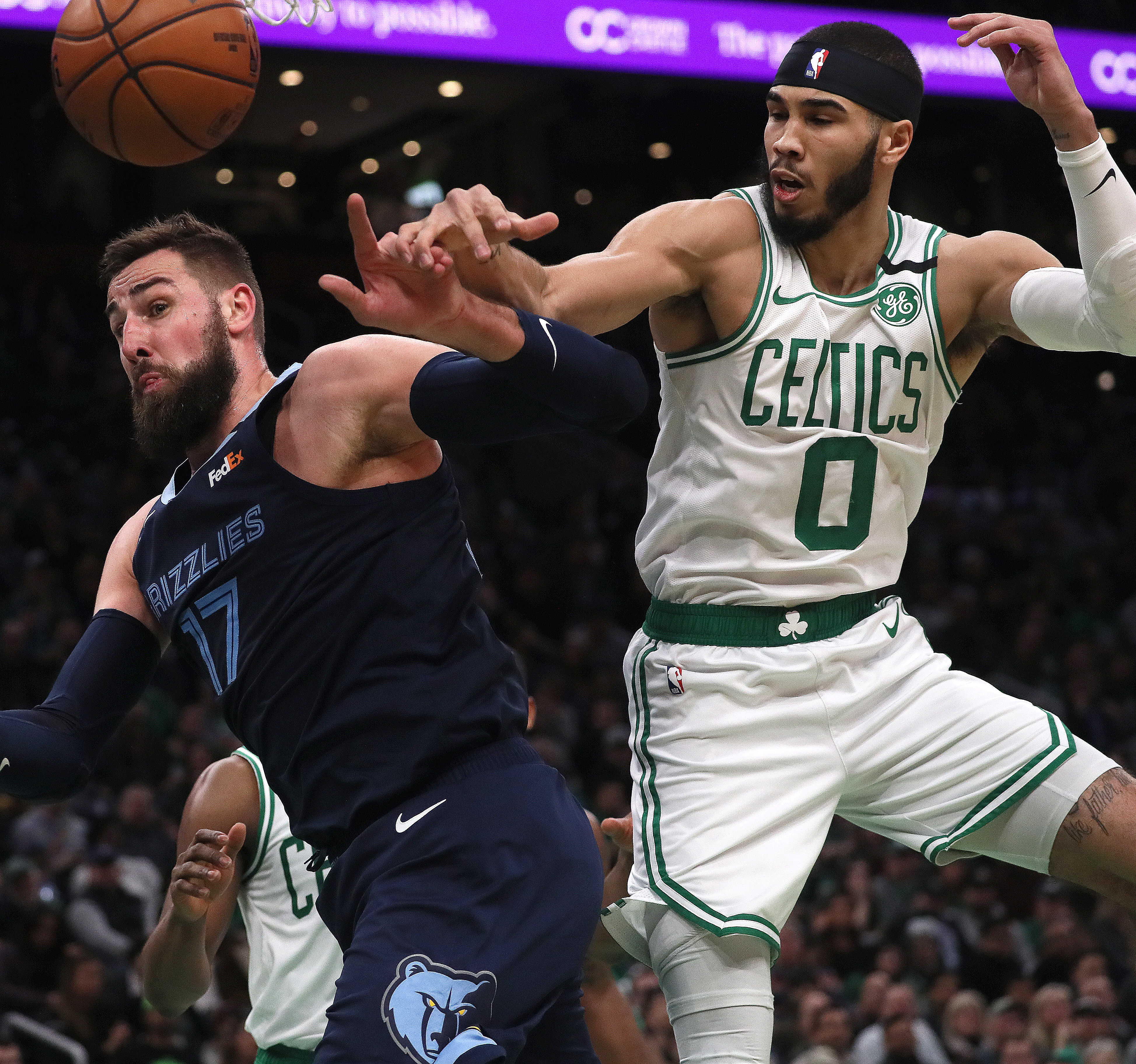 Memphis center Jonas Valanciunas and Jayson Tatum fight for a rebound in the second quarter Wednesday night. Tatum would later depart with an injury.