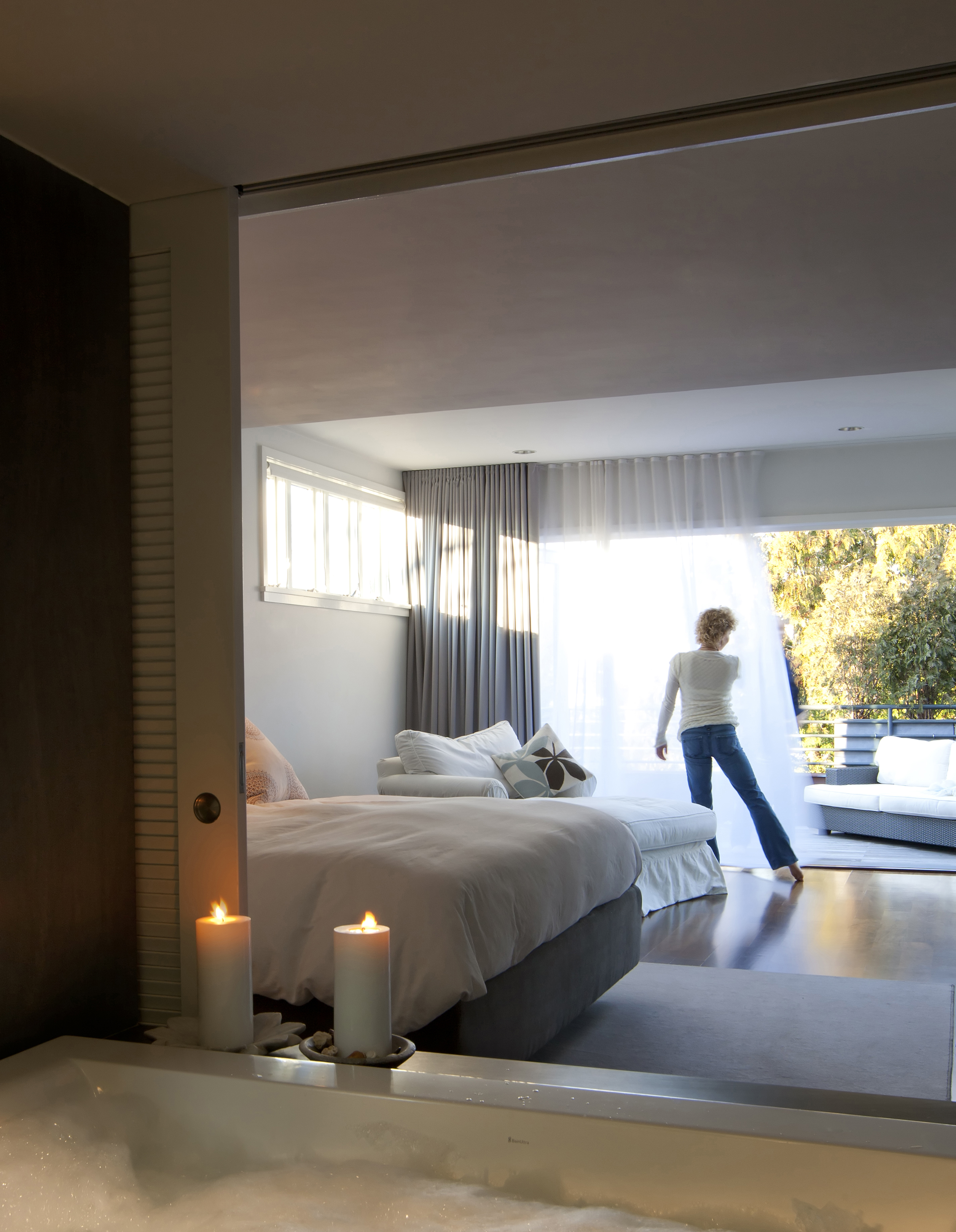 <b>FRESH AIR </b>Kelly and Clint Clemens’s clean, contemporary bedroom has radiant-heat birch floors and opens onto a deck.