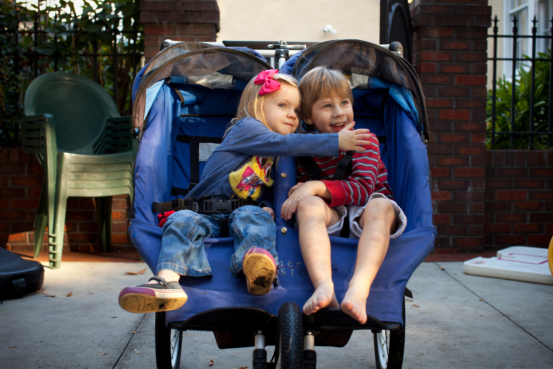 Grace Gilmore and her brother, Brooks Lennon, played together in their stroller while waiting to be taken for a walk around their neighborhood in Tampa.