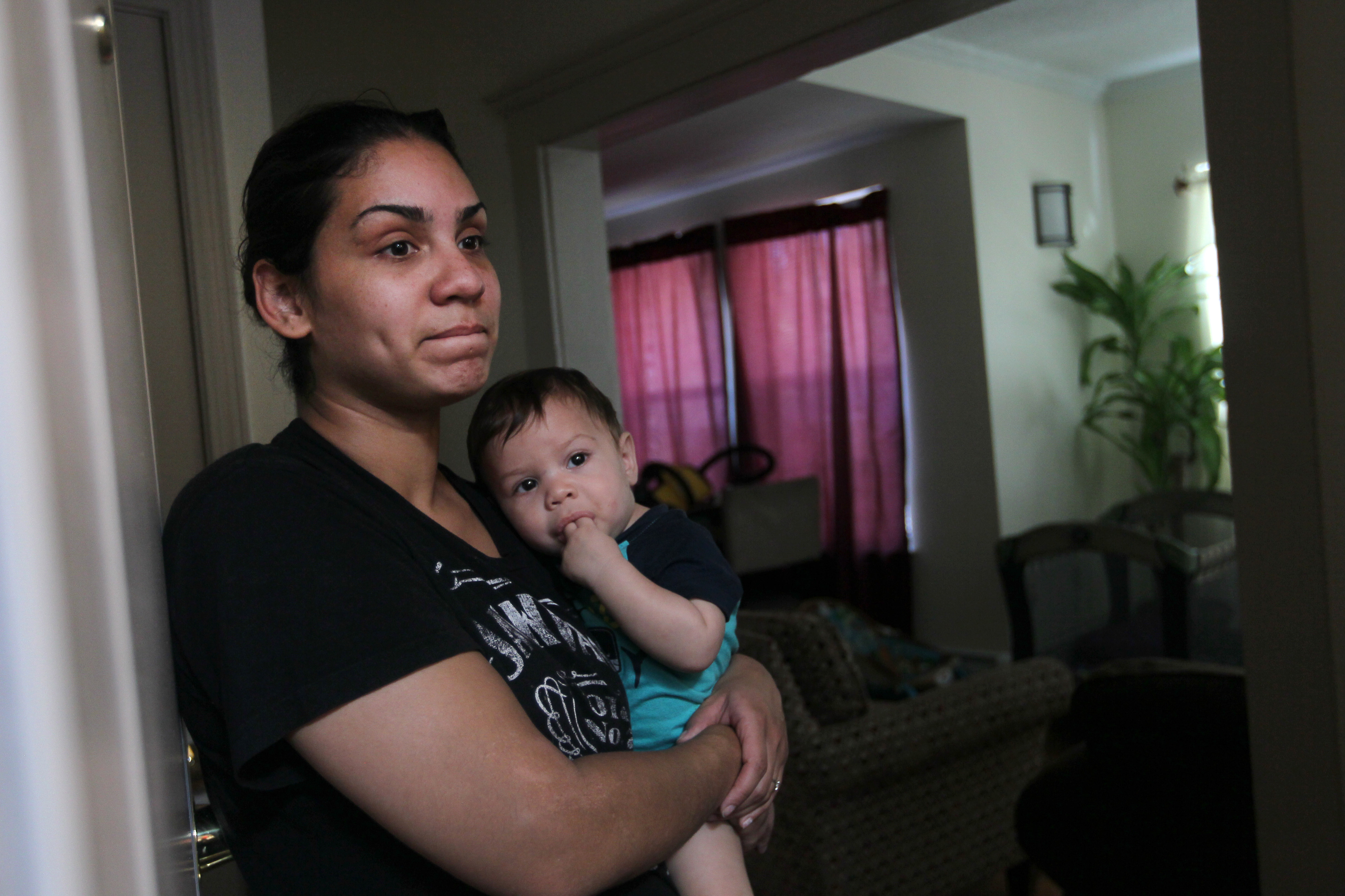 Siomy Torres with her 8-month-old son talks about her next door neighbor.