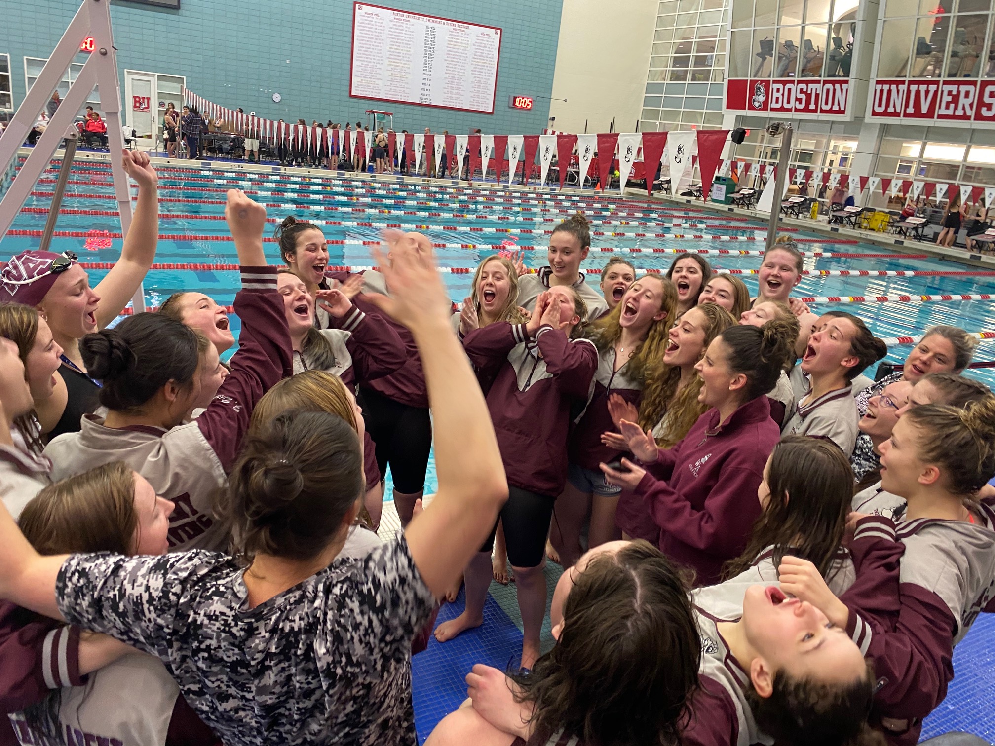 The Westford Academy girls’ swim team howls in delight after winning its fifth consecutive MIAA D1 state title.