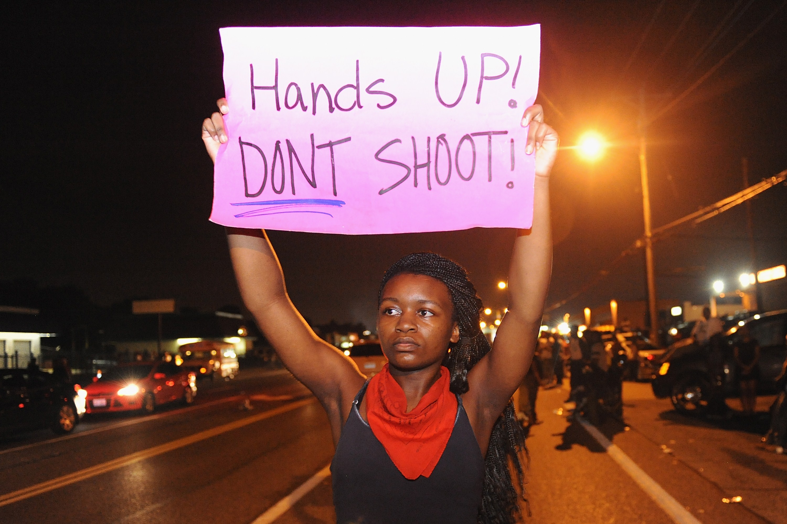 Protestors held signs during a protest on West Florissant Road in Ferguson.