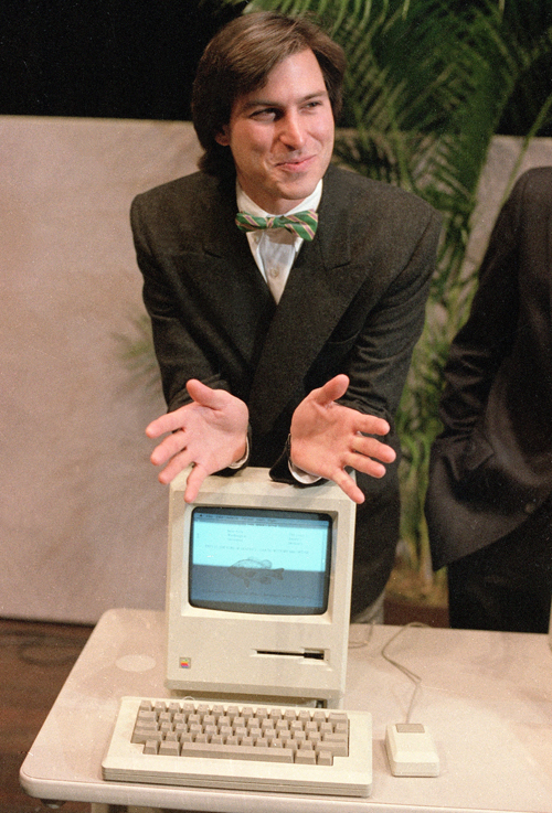 Steve Jobs leaned on the new Macintosh personal computer following a shareholders’ meeting in 1984.