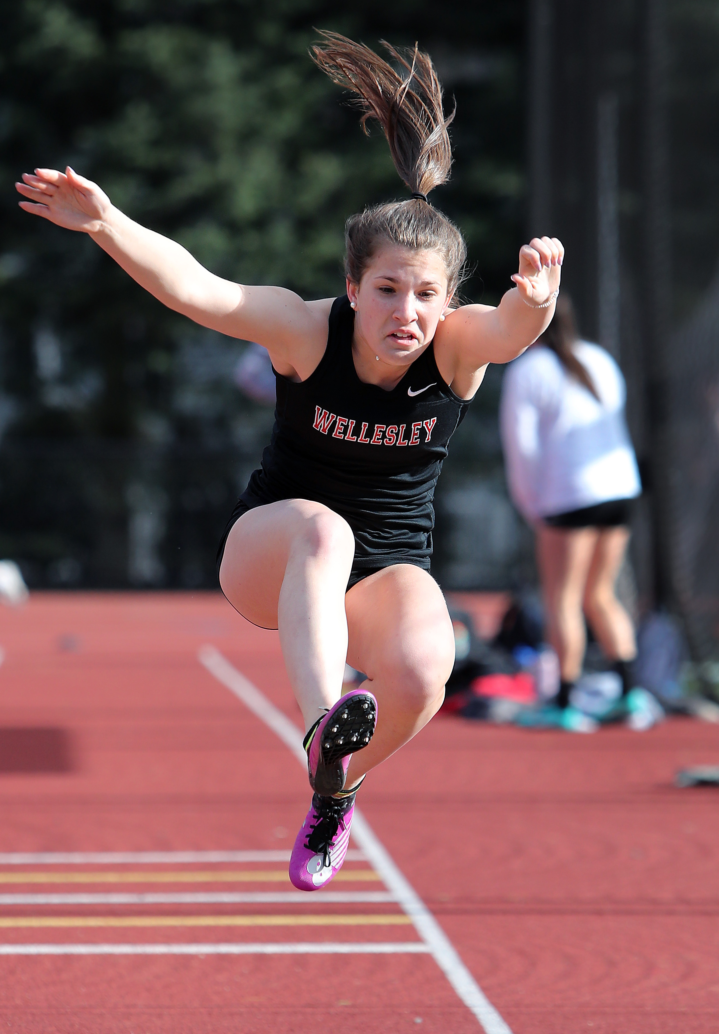 Wellesley’s Charlotte Freniere competing in the long jump.