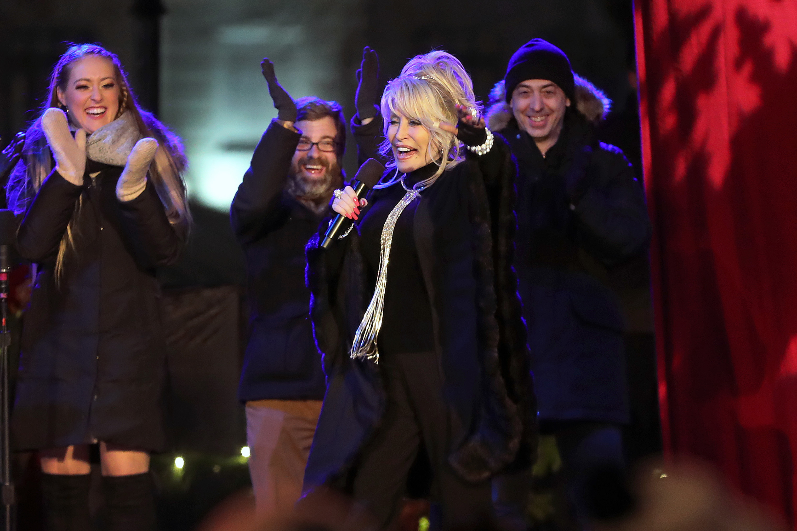 Cast members of "Dolly Parton's Smoky Mountain Christmas Carol" reacted as Dolly Parton herself took the stage to the surprise of the crowd during part of the festivities at the 78th annual tree lighting event on Boston Common.