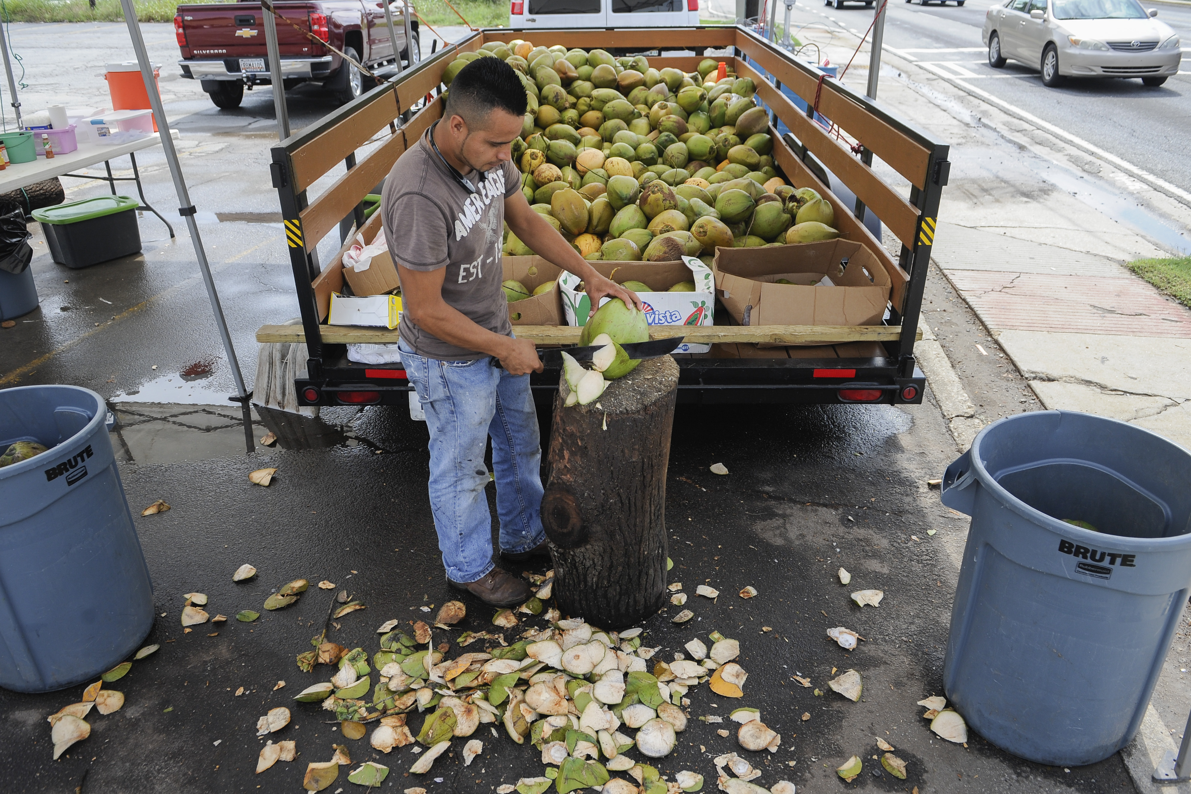 Odilon Rodriguez, of Mexico, is pictured late last month at the coconut stand at which he works alongside Buford Highway, in the vacant parking lot of a one time Dairy Queen, turned cafe, and which is now torn down.