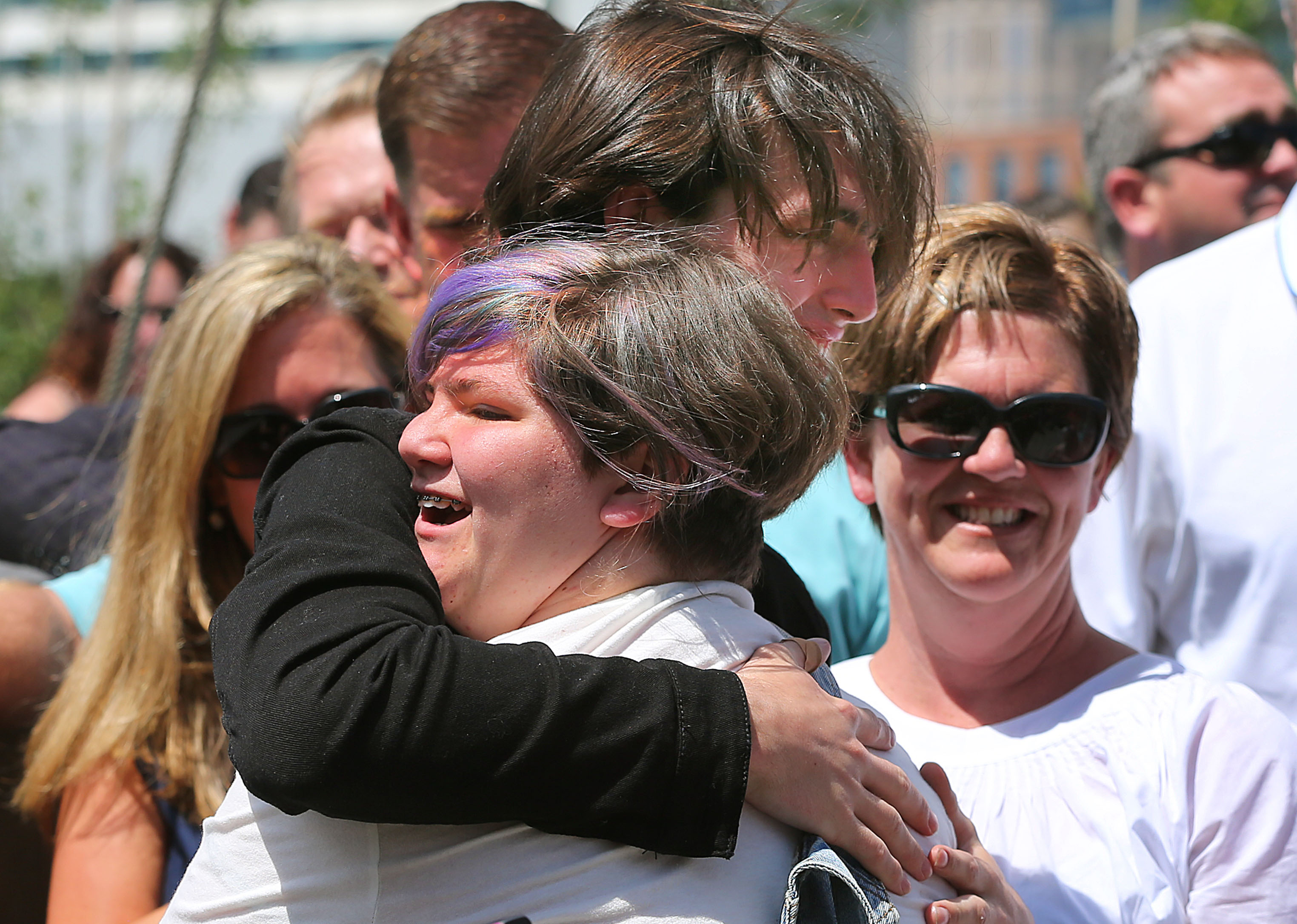Jane Richard, Martin’s sister, was hugged by her brother, Henry, after singing a song at the dedication.
