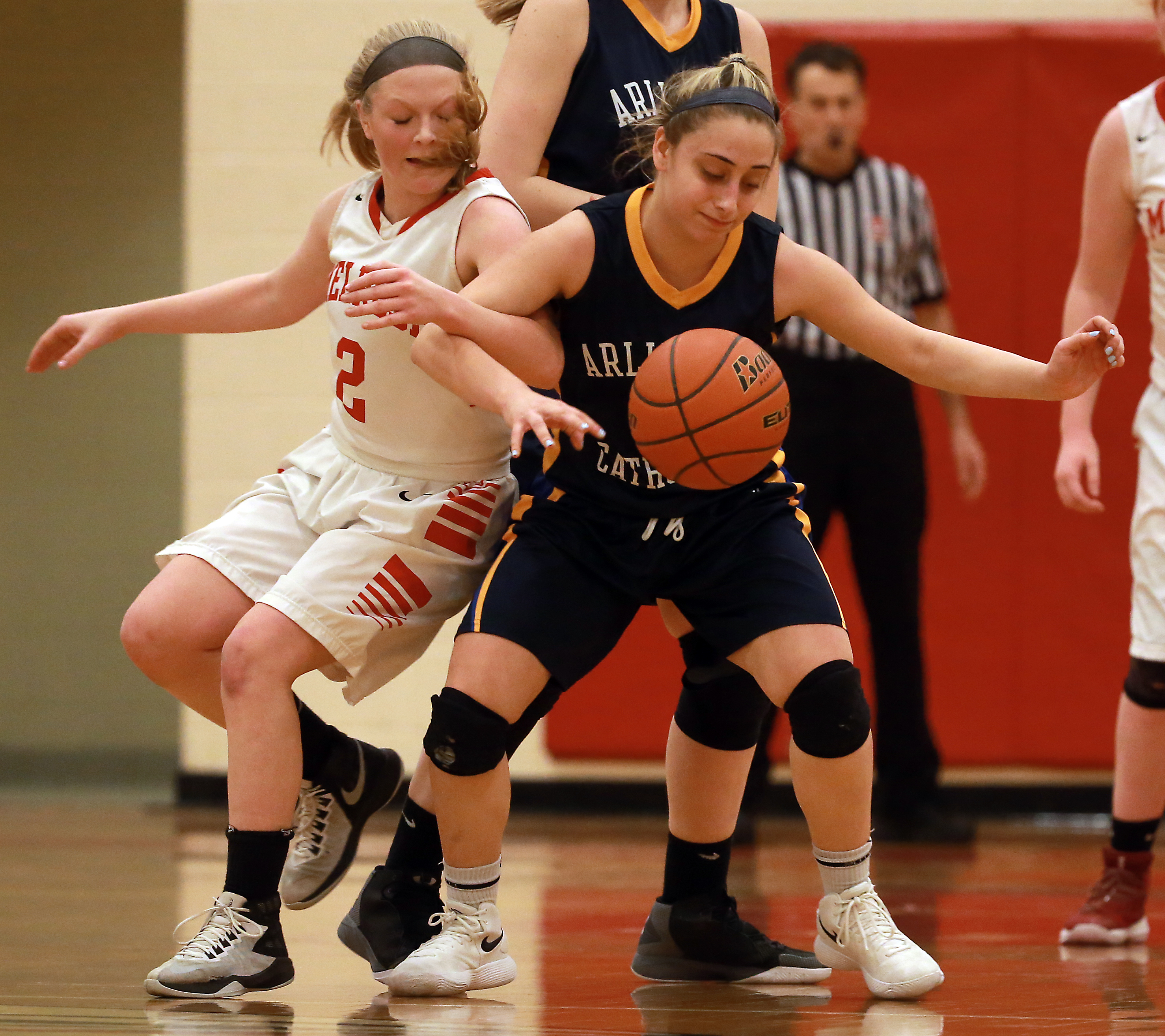 Melrose and Arlington Catholic were locked in a tough first-round battle that went to overtime Tuesday, as exemplified bythe second-quarter loose ball battle between Melrose’s Samantha Smith (left) and Arlington Catholic’s Isabella Petrillo.
