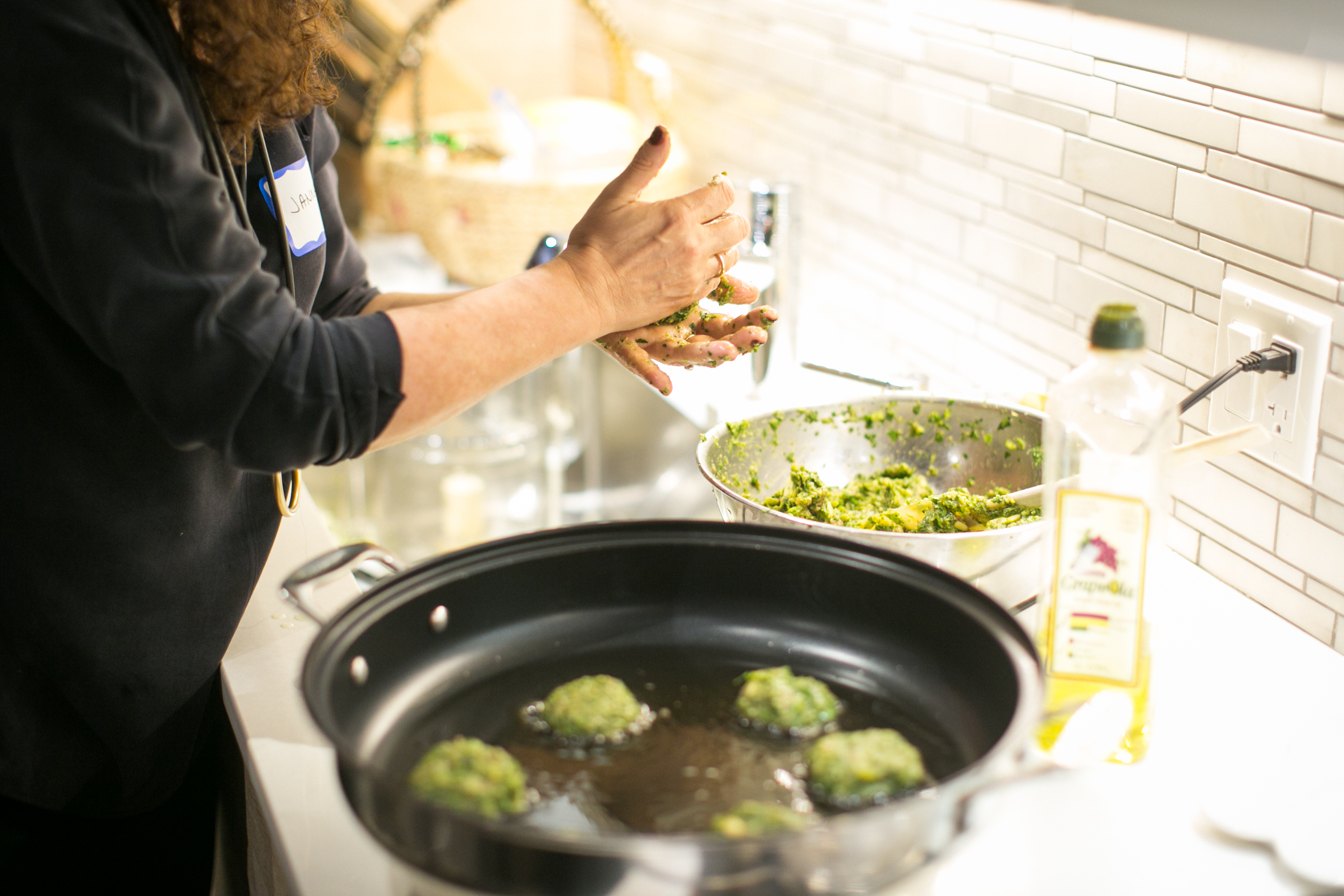 Janna Gur making herb and meat latkes.