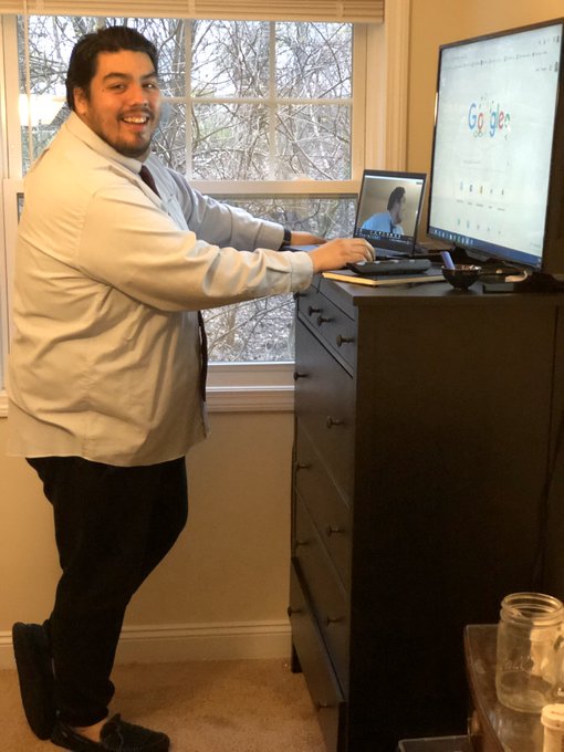 Chris Flores works from home in a shirt and tie — and sweat pants.