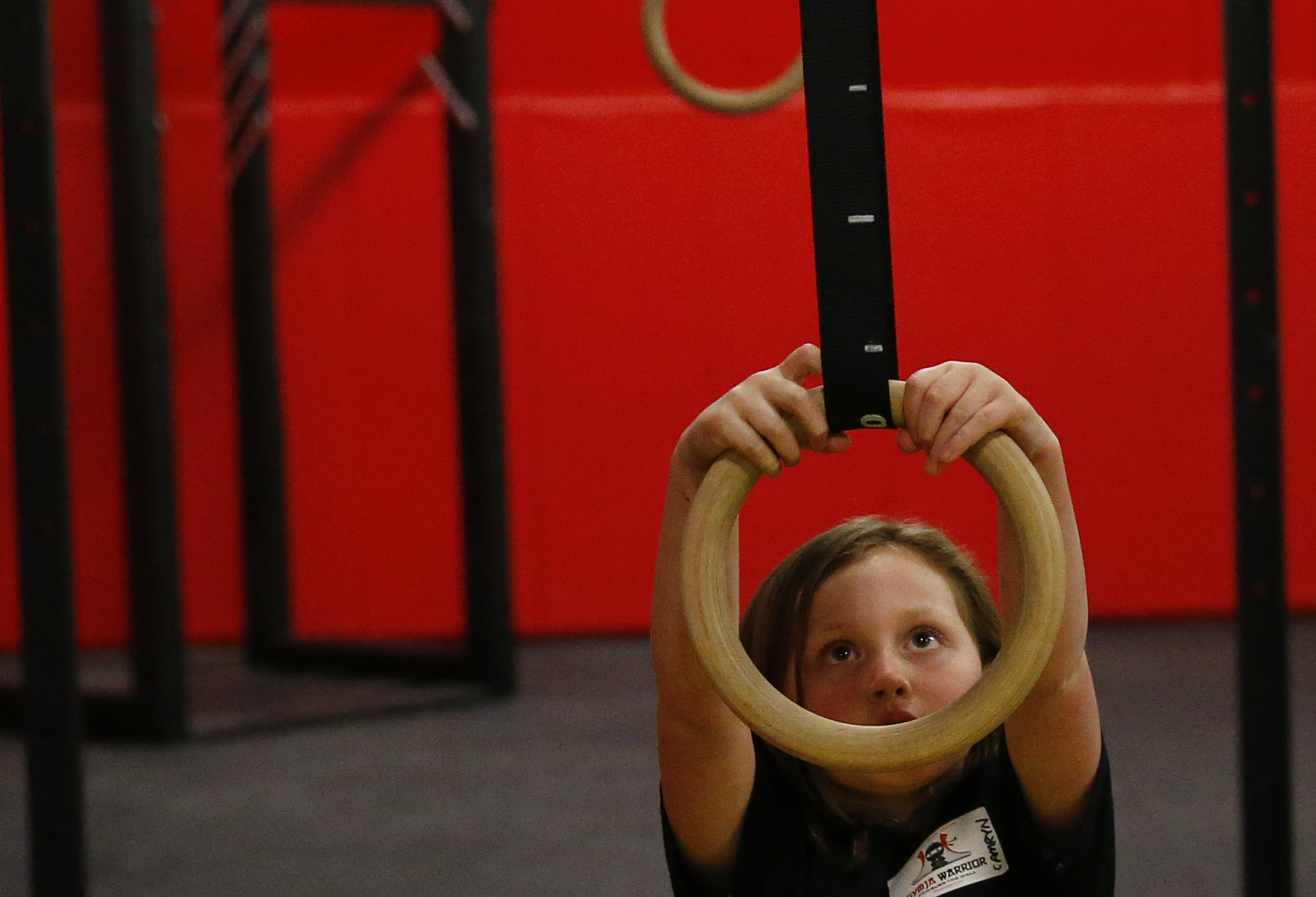 Camryn Knoblauch, 8, of North Andover swung on a ring during an American Ninja Warrior training course at Gymja in Danvers.
