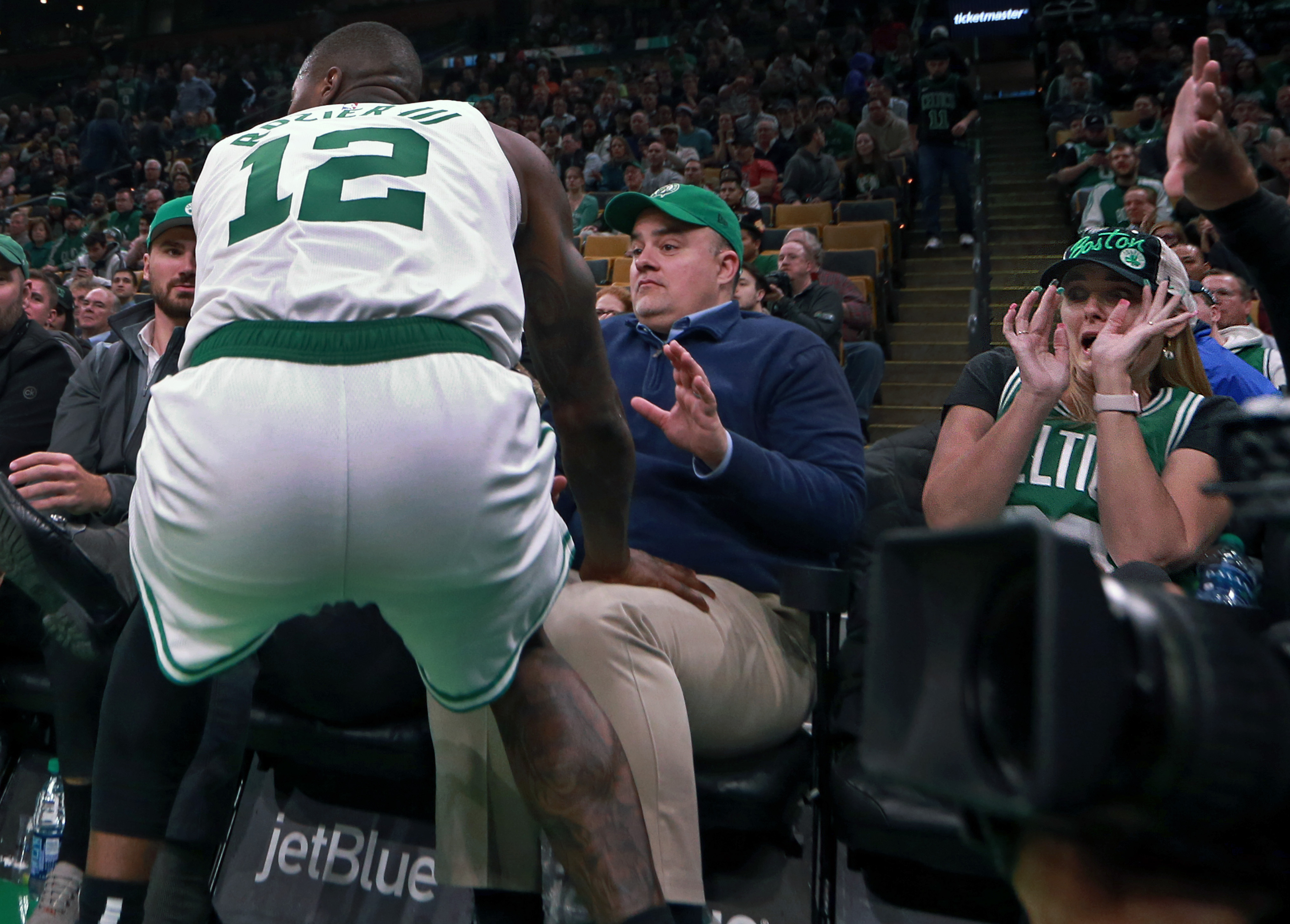 A woman in a courtside seat recoils as the Celtics’ Terry Rozier heads her way in the fourth quarter.