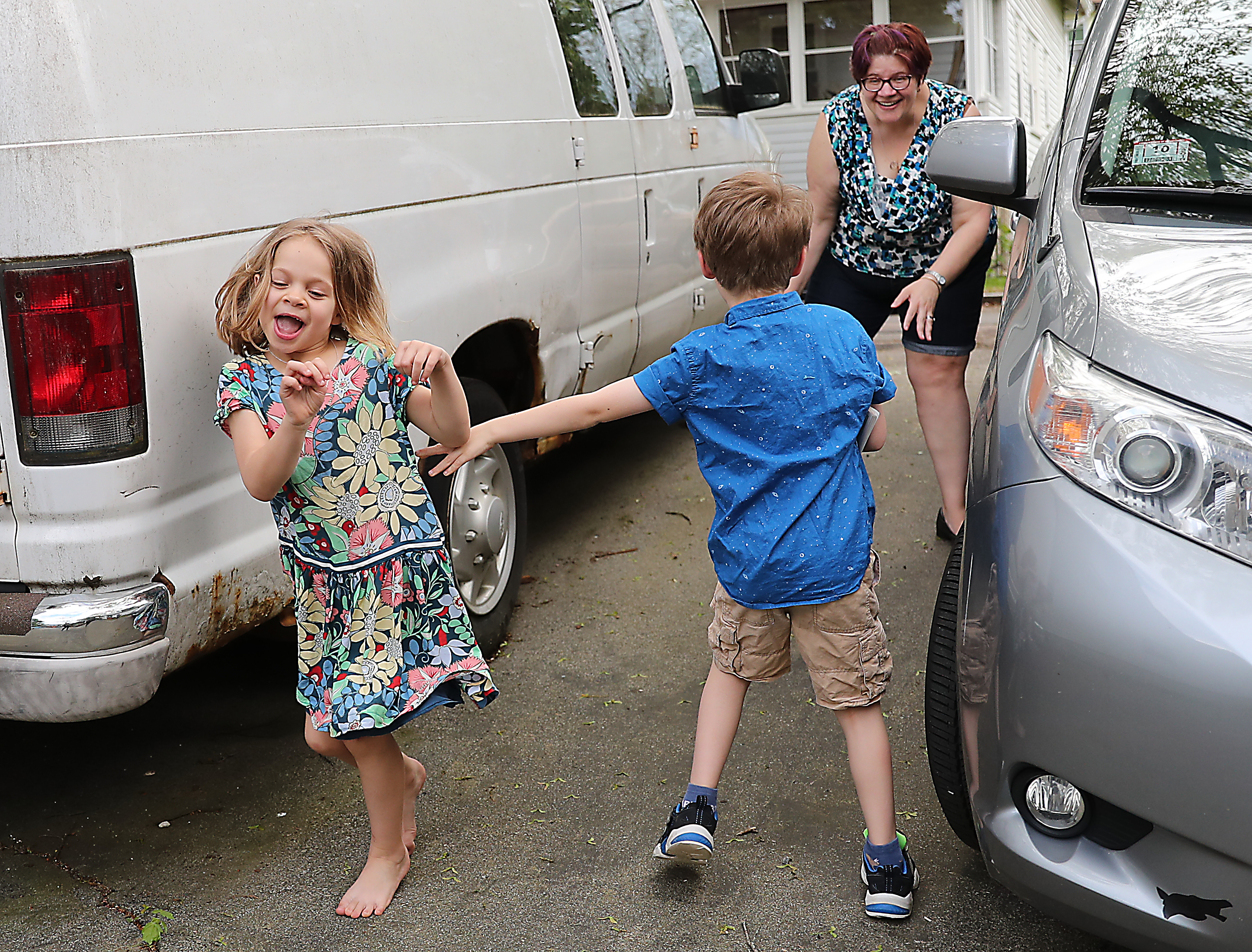 Carrie Hamilton played tag with her twins, Ella and Sam Bardwell, 7, in their driveway.