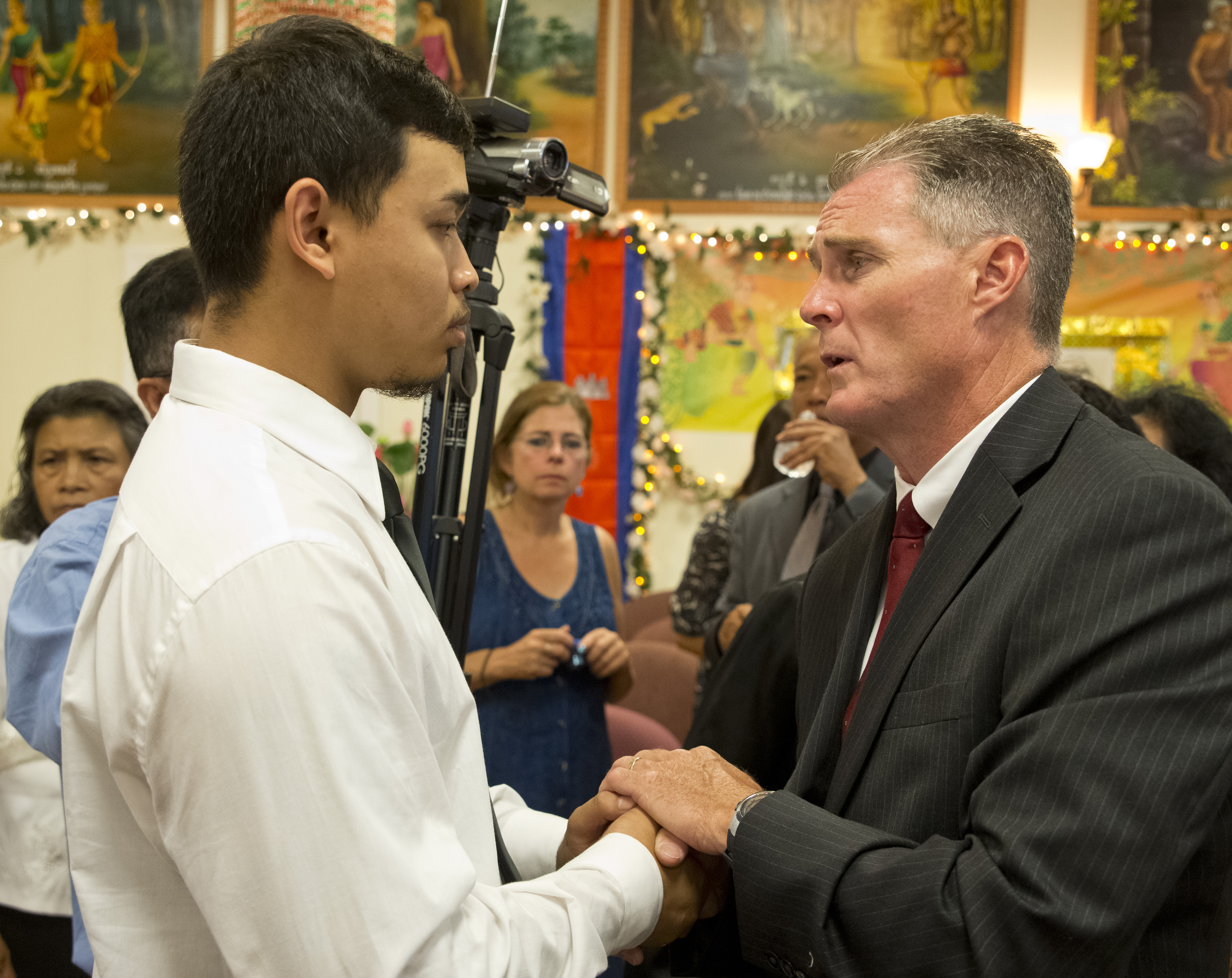 Lowell Mayor Rodney Elliott (right) spoke with Thearan Sak, who lost his brother, his brother’s girlfriend, and three of the couple’s five children in Thursday’s fire.