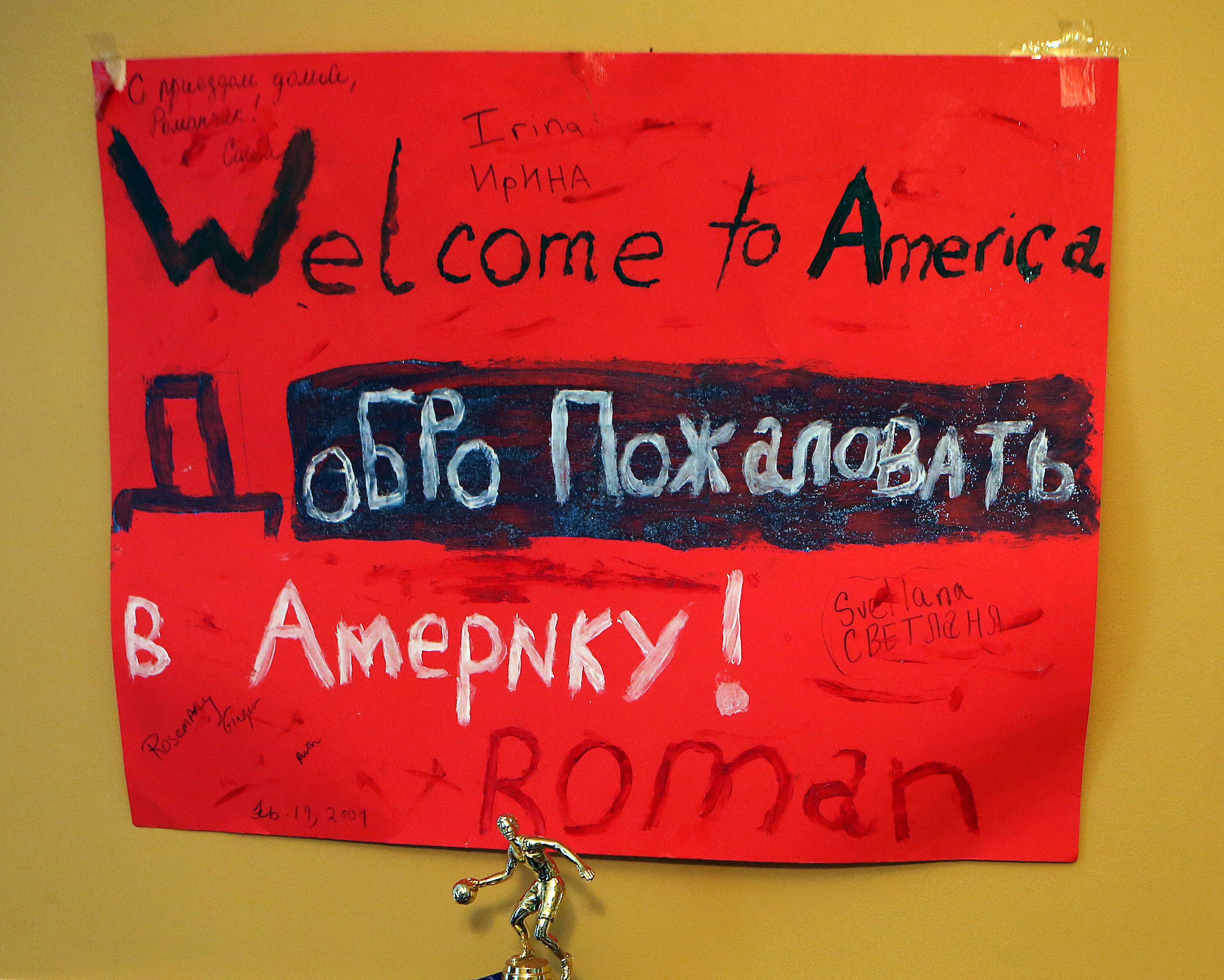 A poster that welcomed Roman five years ago still adorns the wall of his home.