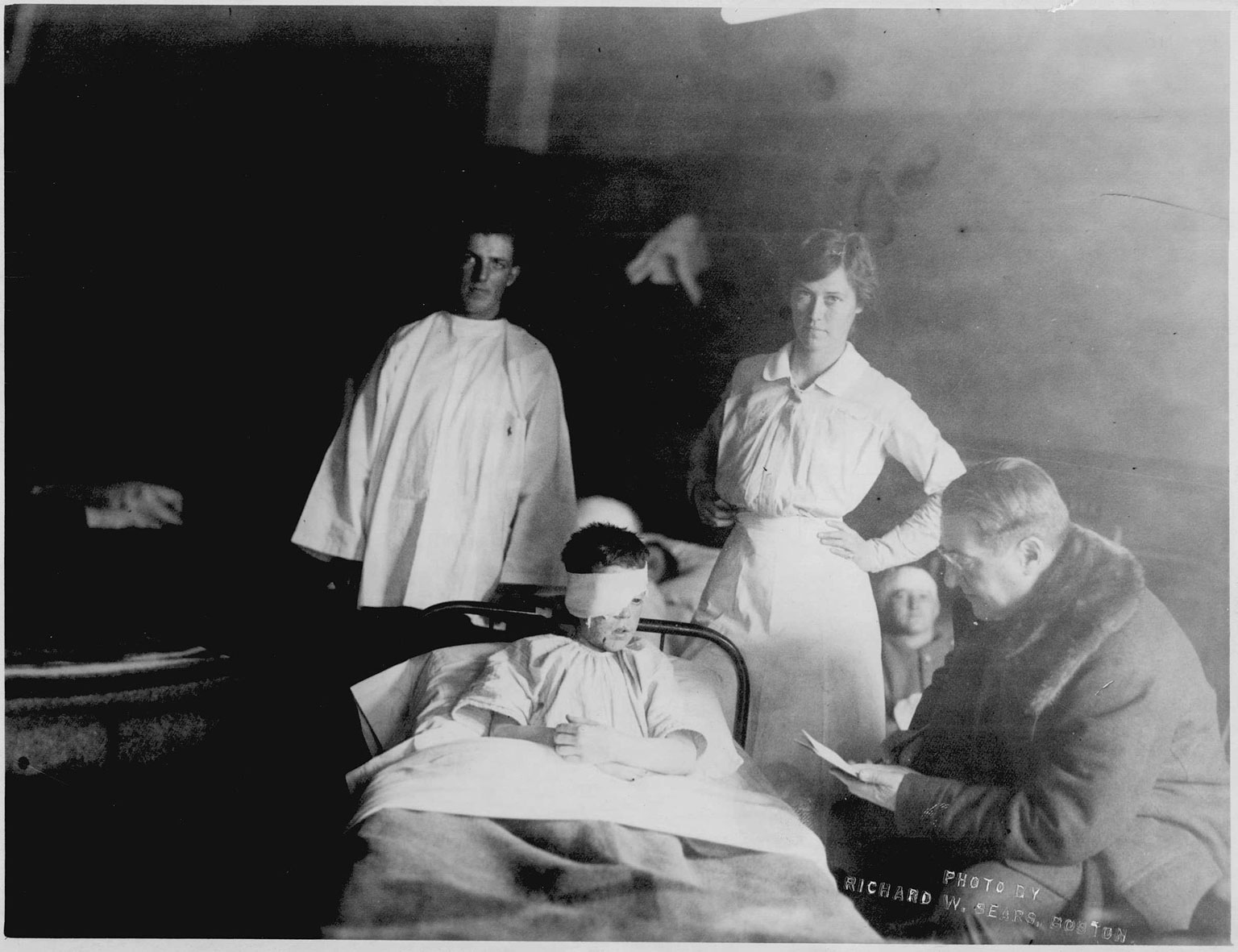 A.C. Ratshesky sits with George Arthur, wounded in the explosion, and Boston nurse Edith Choate.