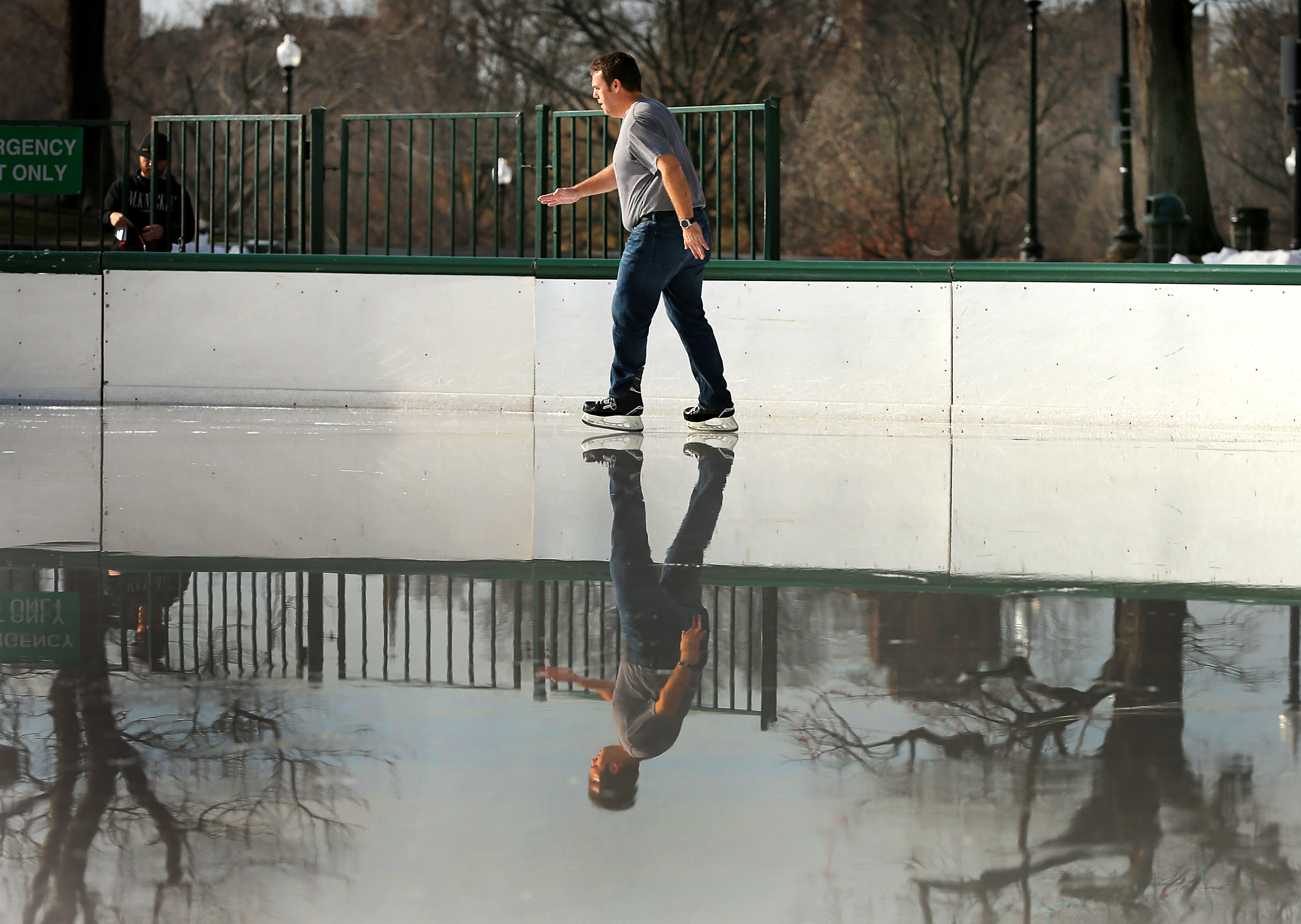 Paul Mueller from Houston, Texas, skated in his t-shirt on the watery ice of the Boston Common Frog Pond on Thursday.