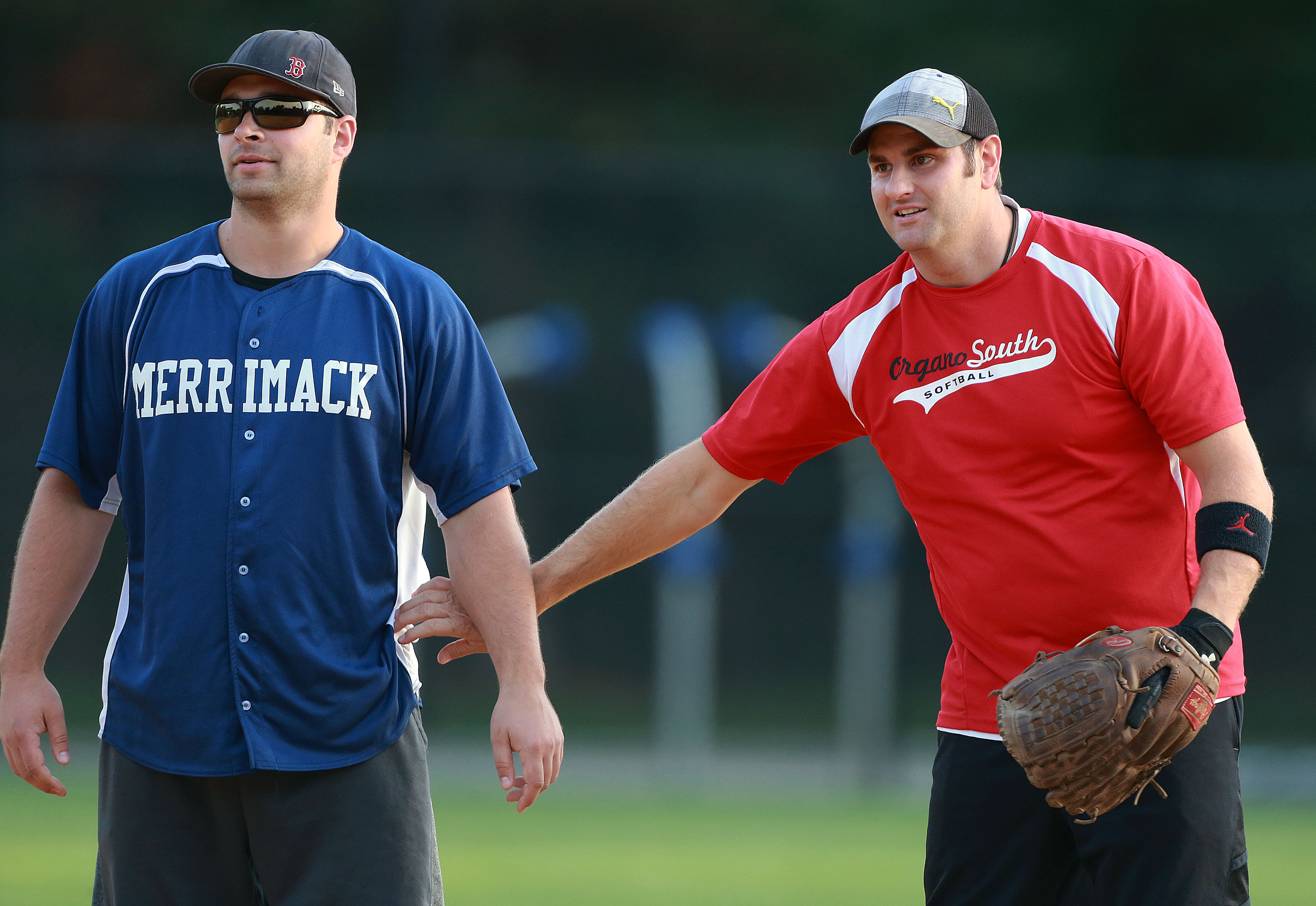 Andrew Reardon, second baseman for Organogenesis, had a friendly pat for Joe Dobbins of Merrimack Pharmaceuticals when he reached second base during a recent game.