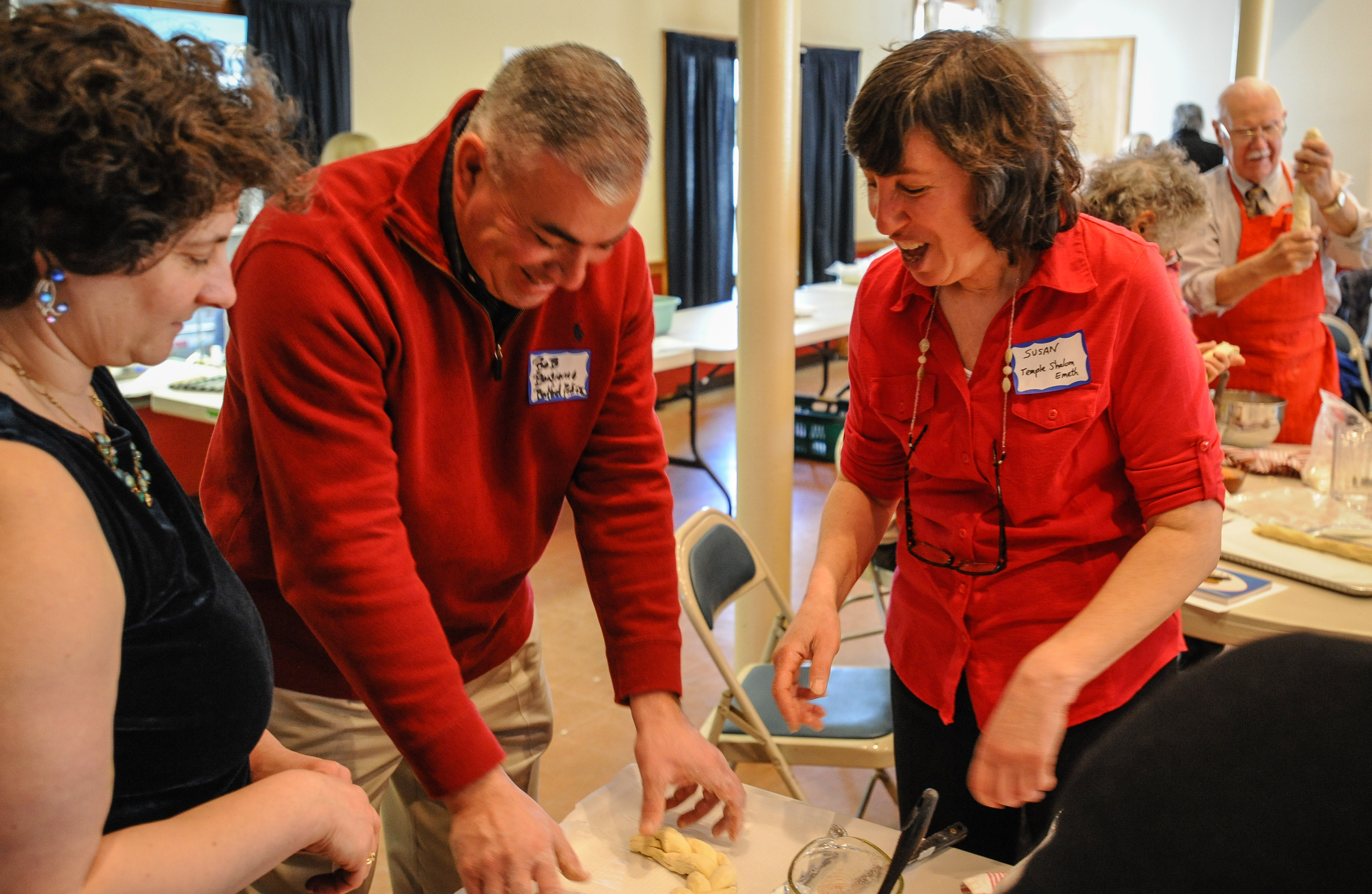 Police Chief Robert Bongiorno (center) and Rabbi Susan Abramson (right) at a lesson in challah making.