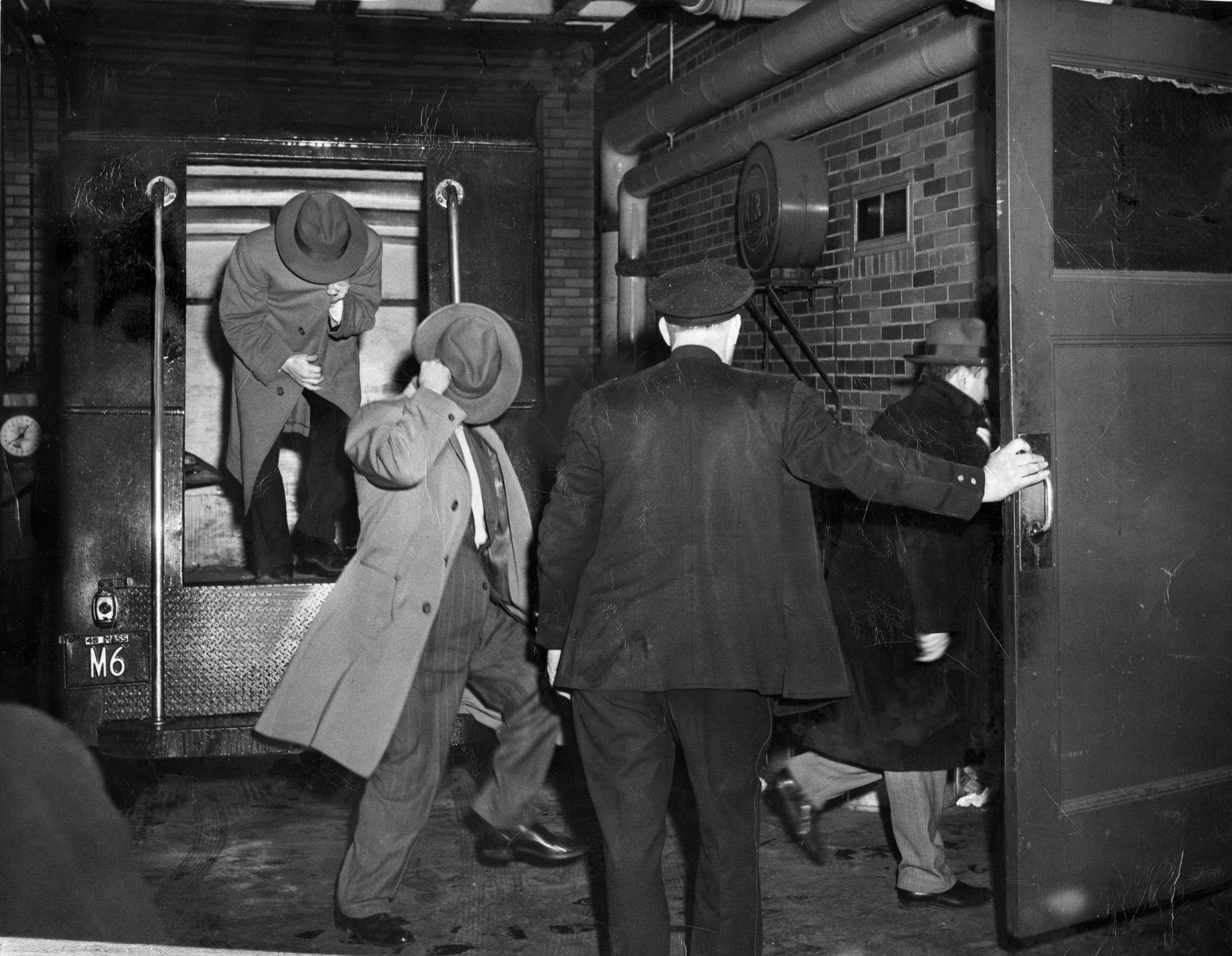 Men picked up for questioning in connection with the Brink's robbery walked into Station 1 in Boston on Jan. 24, 1950.