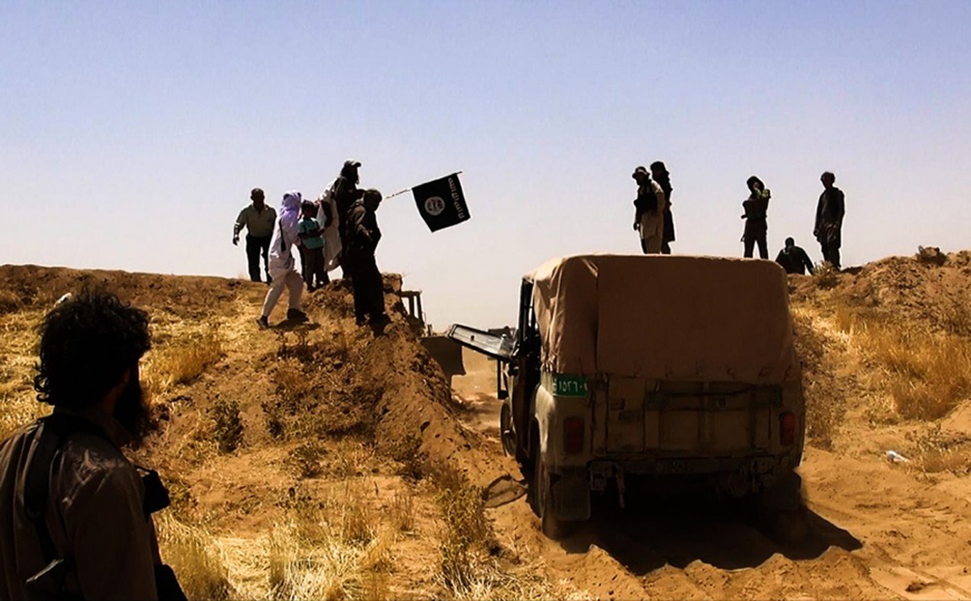 ISIS militants breach the Syrian-Iraqi border, aiming to carve an extremist state out of Sunni-dominated swaths of the two countries.