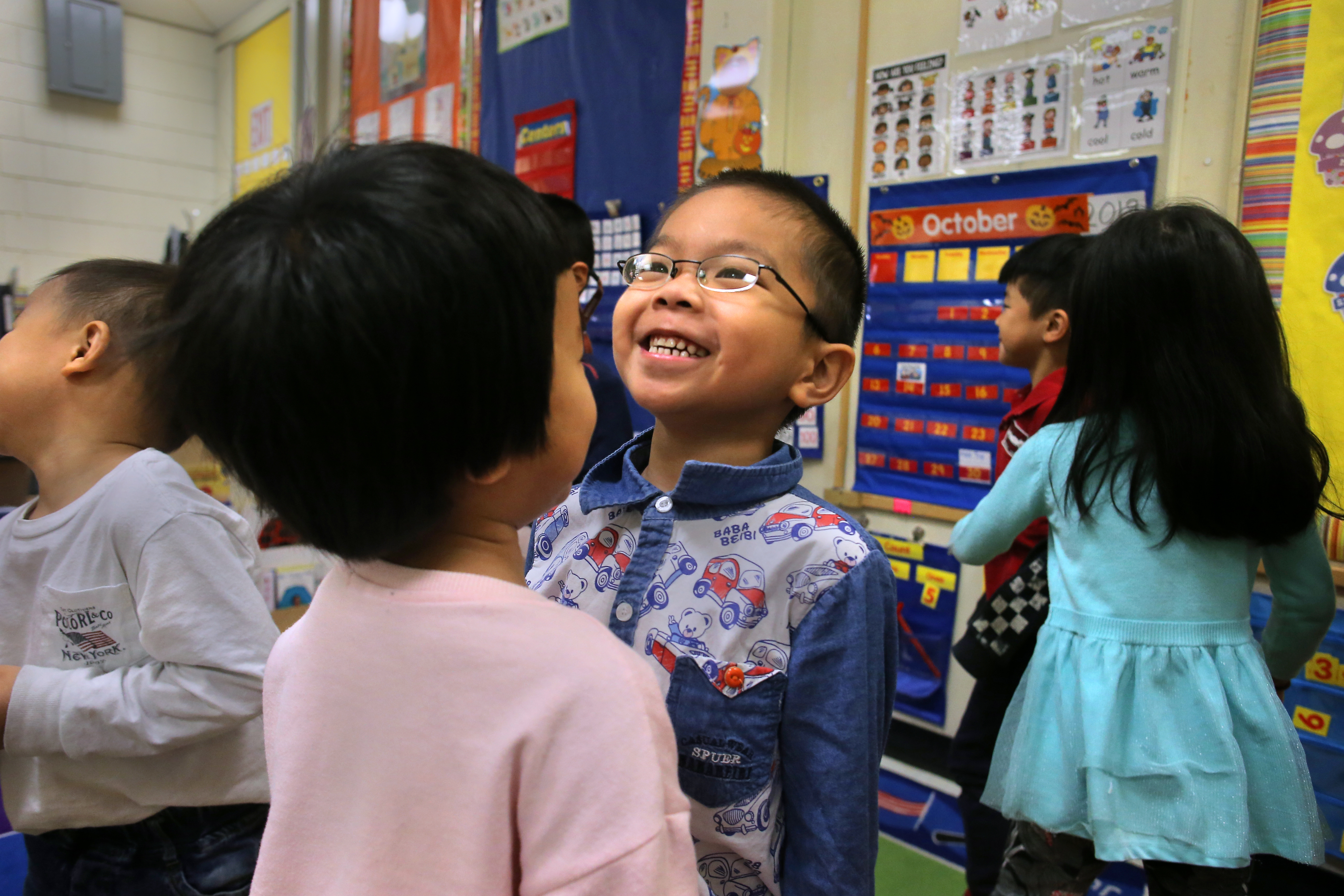 Vicky Chen (left) and ZhiQiang Zheng practiced introducing themselves in Mandarin. Kindergartners study Mandarin in teacher Xiao Ping Xie's class at the Josiah Quincy Elementary School in Chinatown.