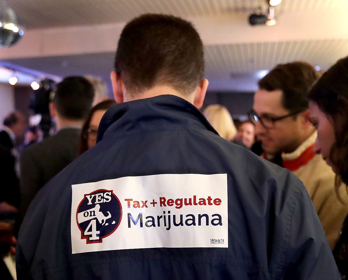 A supporter of the ballot question to legalize recreational use of marijuana in the state wore a message on his jacket at an Election Night rally at Lir restaurant.