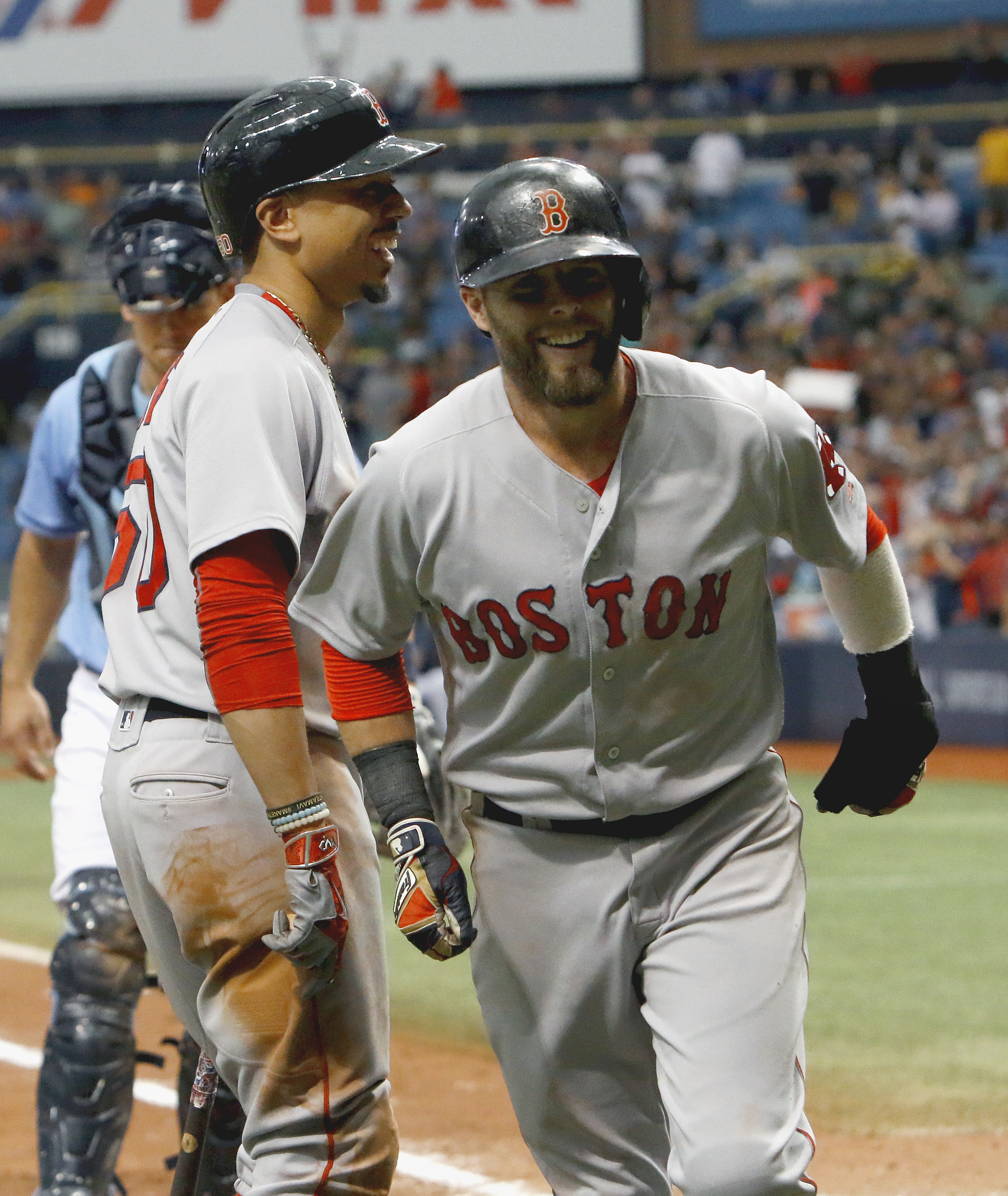 Dustin Pedroia trots back to the dugout after scoring what proved to be the winning run Sunday.