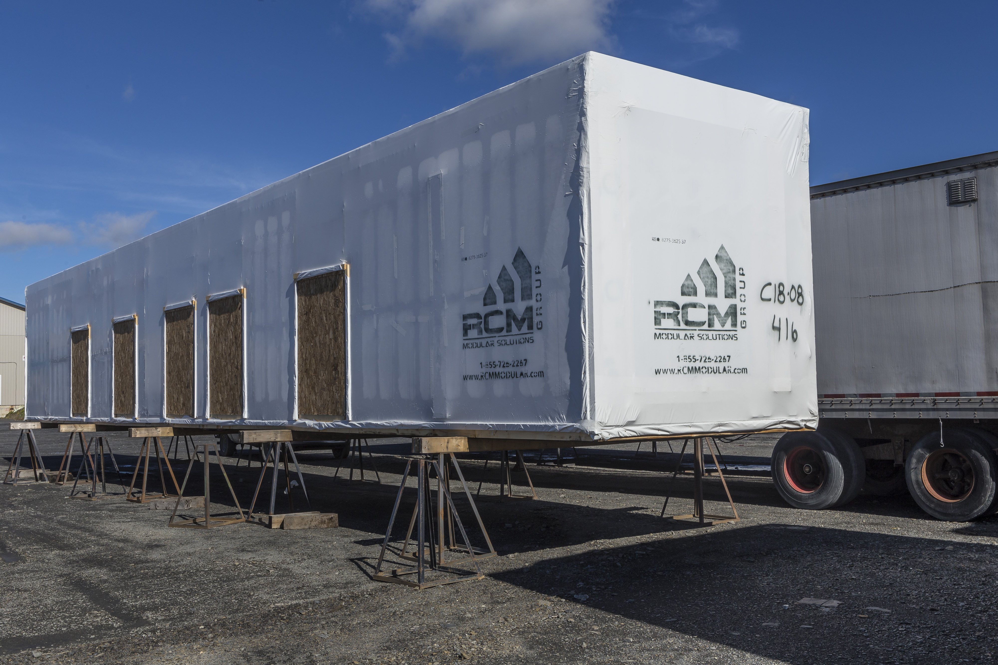 Wrapped and ready to be shipped, completed modular homes wait at the RCM Group yard.