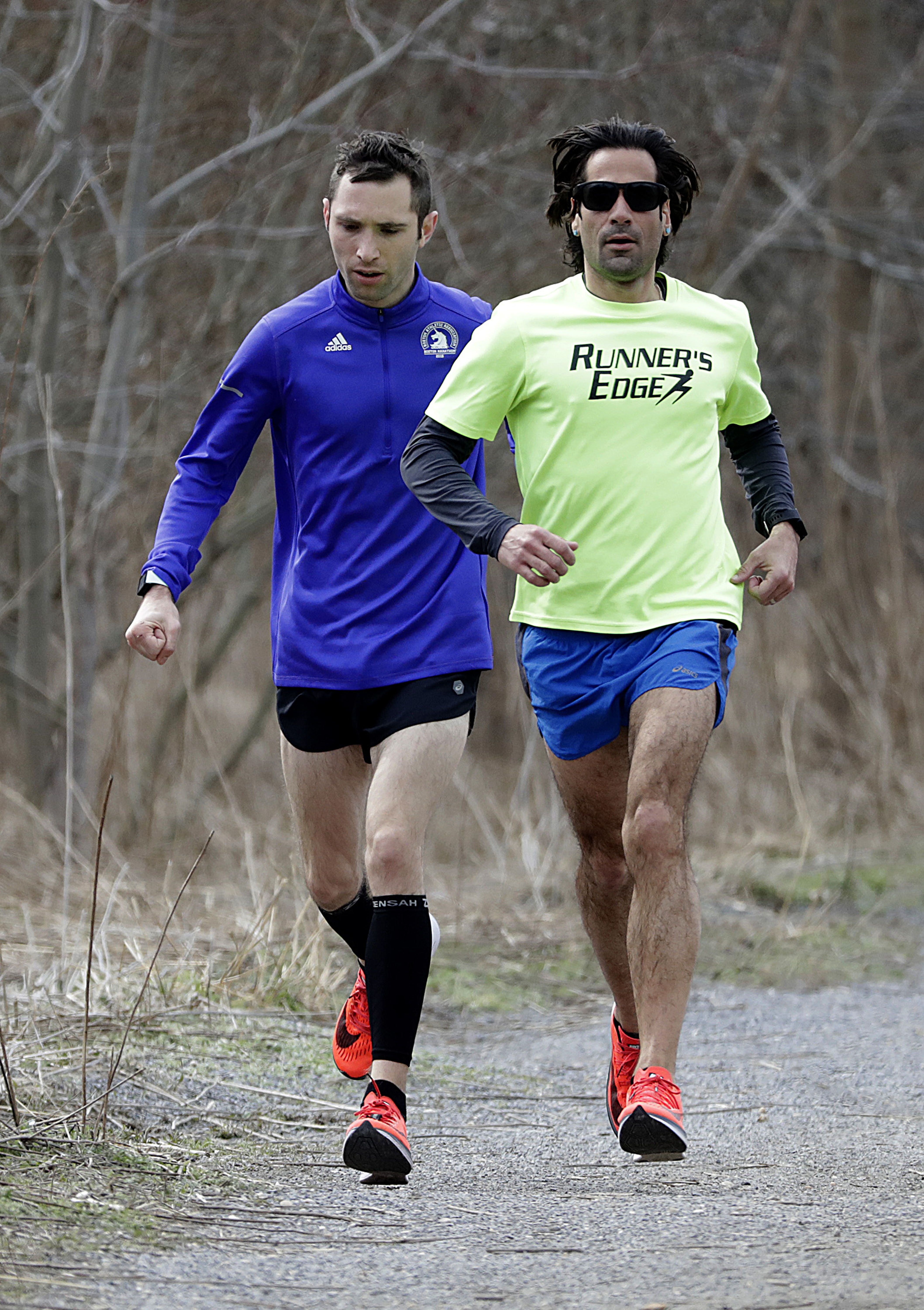 Alex Schneider (left) ran along a trail with trainer Sal Nastasi while preparing for Boston.