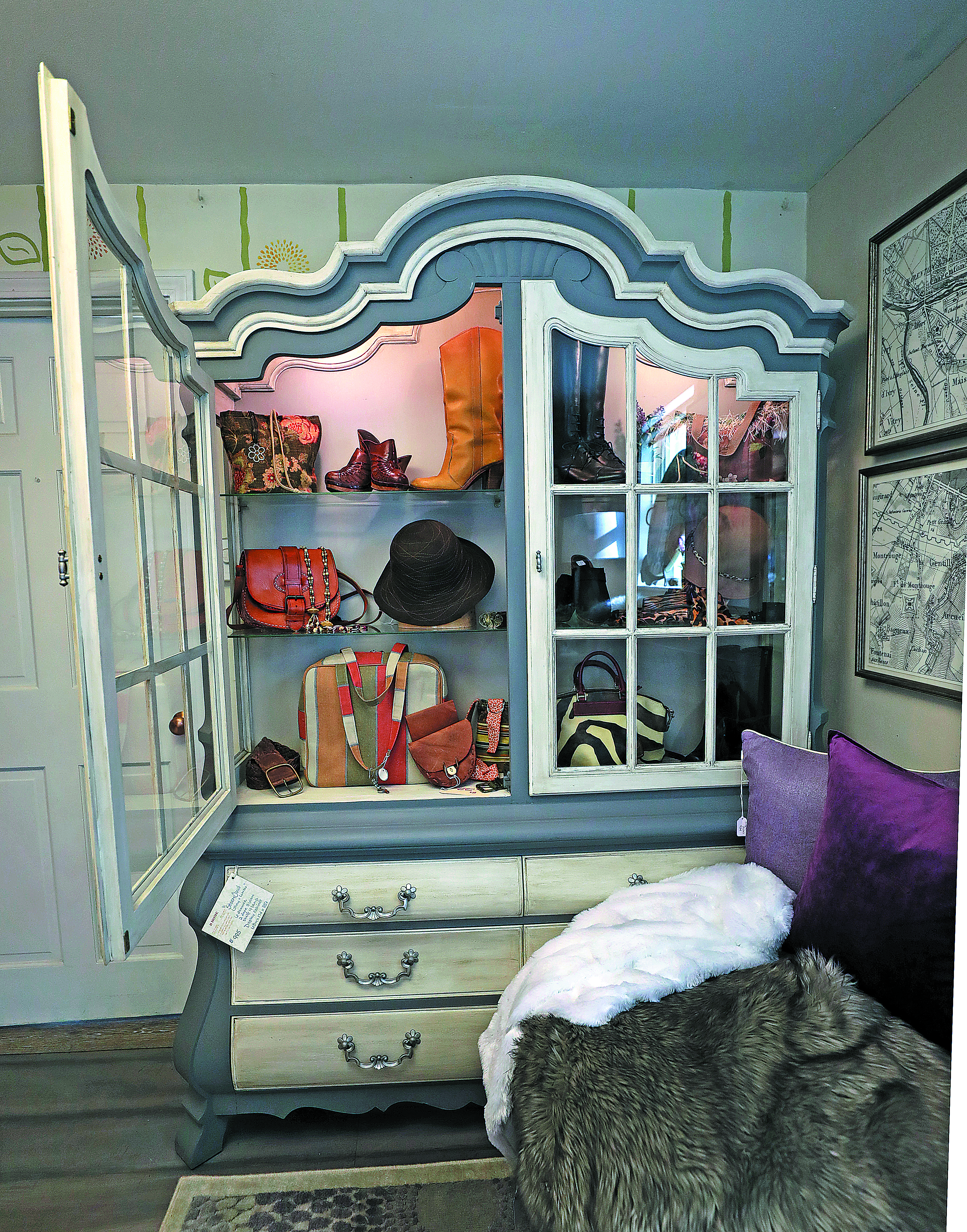 A cabinet was repurposed as a closet for bags, footwear, and the like.