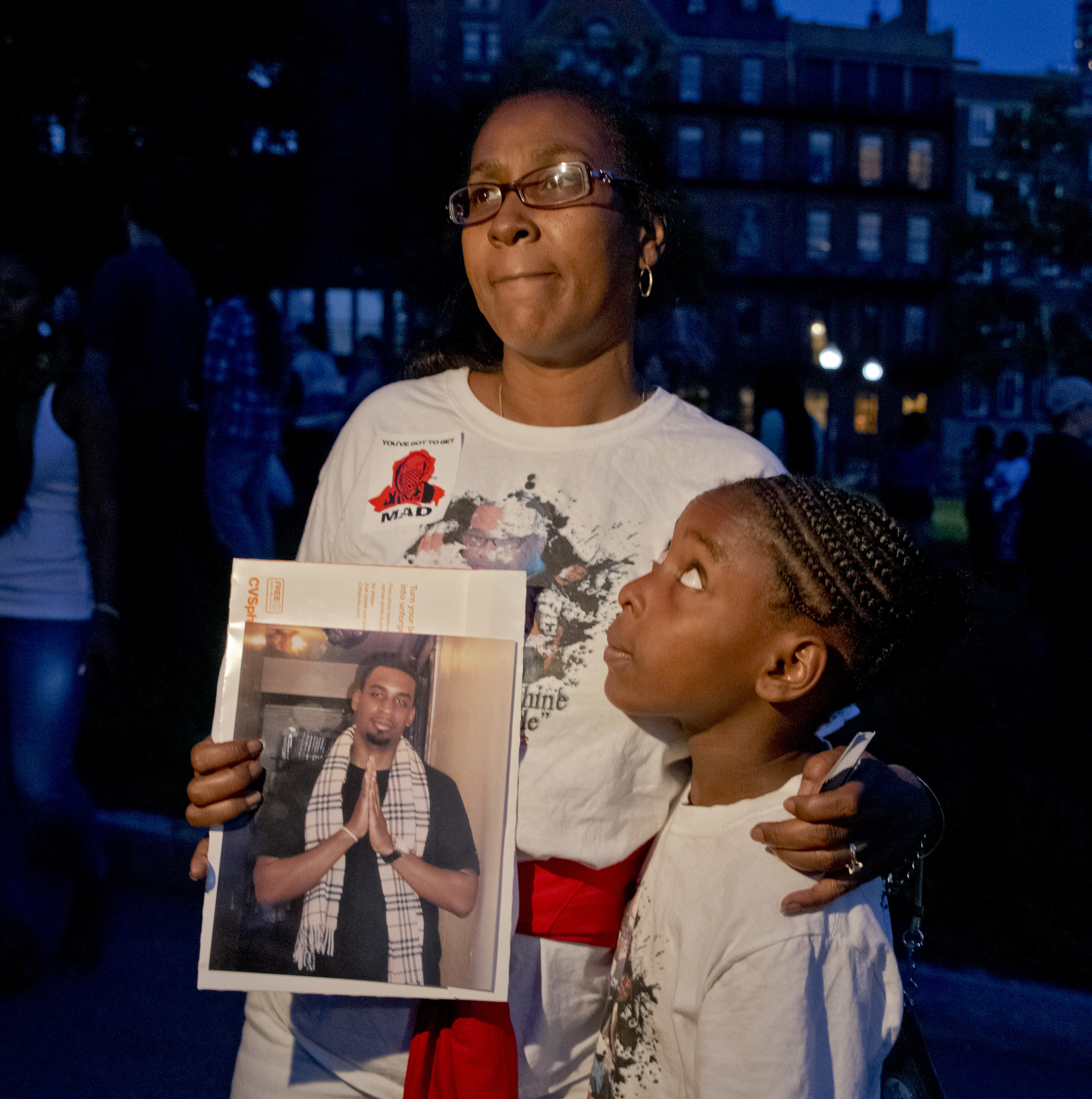 Carla Sheffield with her daughter, 10-year-old Zyariah, held a picture of her son, Burrell Ramsey White, who was fatally shot by Boston police in August 2012. Sheffield was on Boston Common Thursday evening, where people gathered as part of a national rally to protest the death of Michael Brown, 18, who was fatally shot by police in Ferguson, Mo.