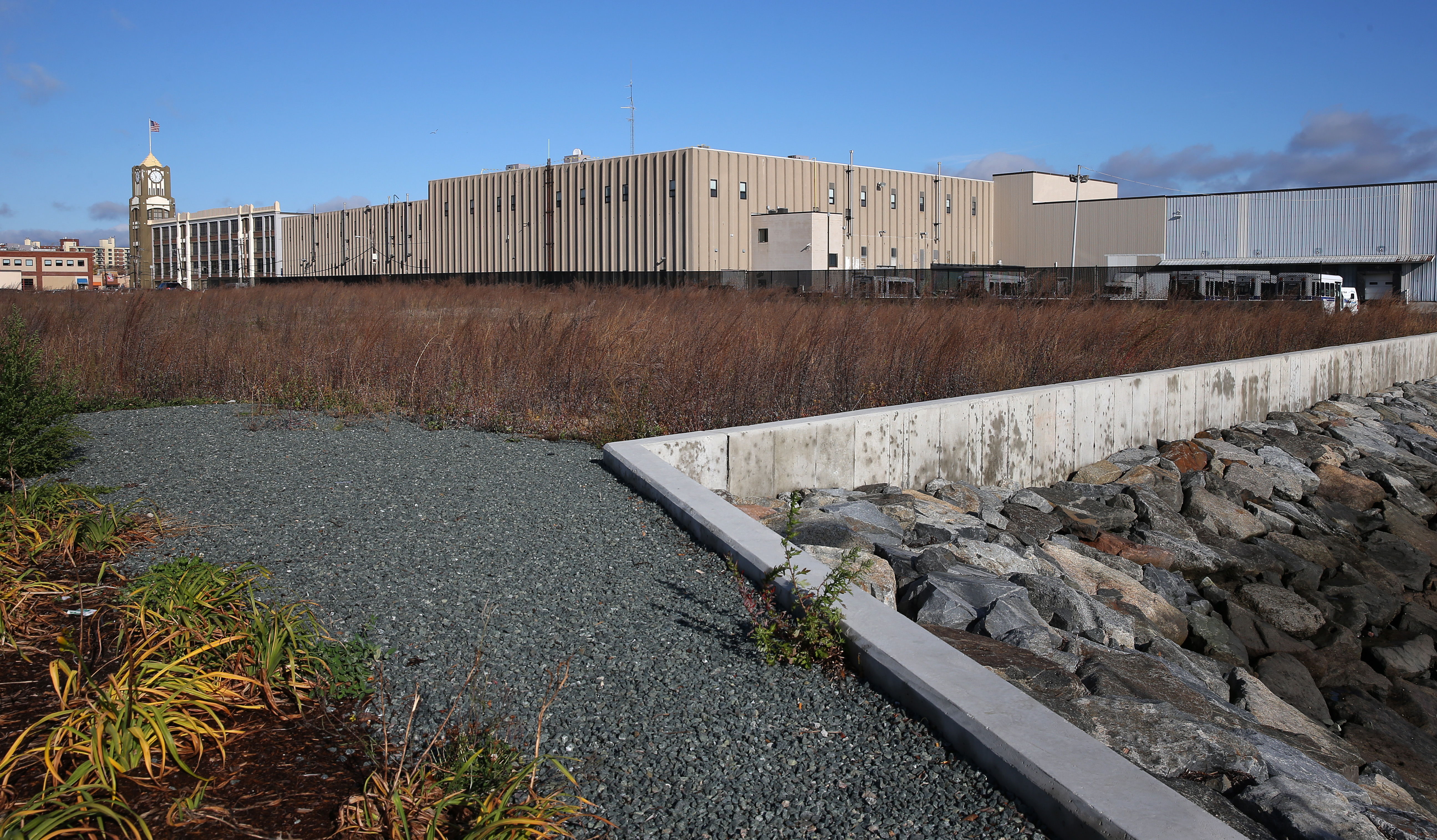 A development on the site of a former Chevrolet dealership, near the Clock Tower Business Center (seen in the distance), would offer more than 300 apartments and quick access to downtown Lynn.